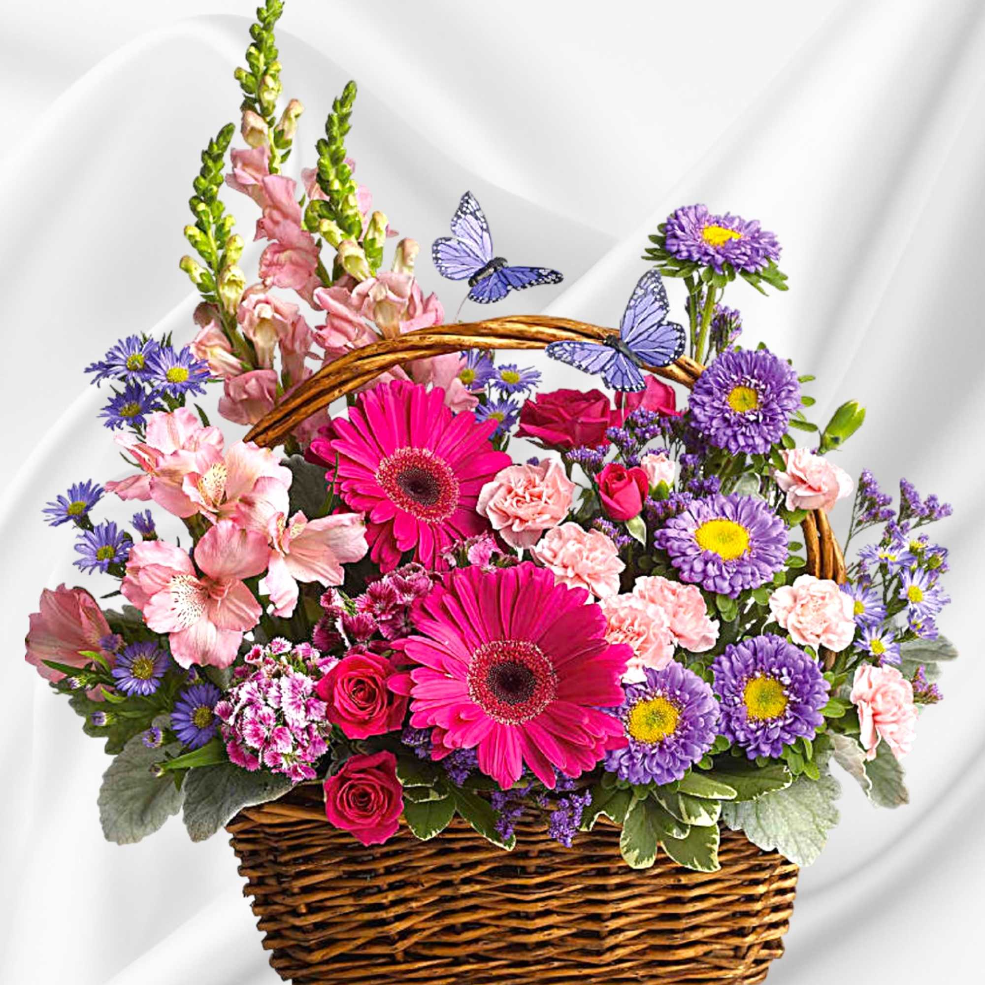 Basket of pink, purple, and magenta flowers with butterfly accents