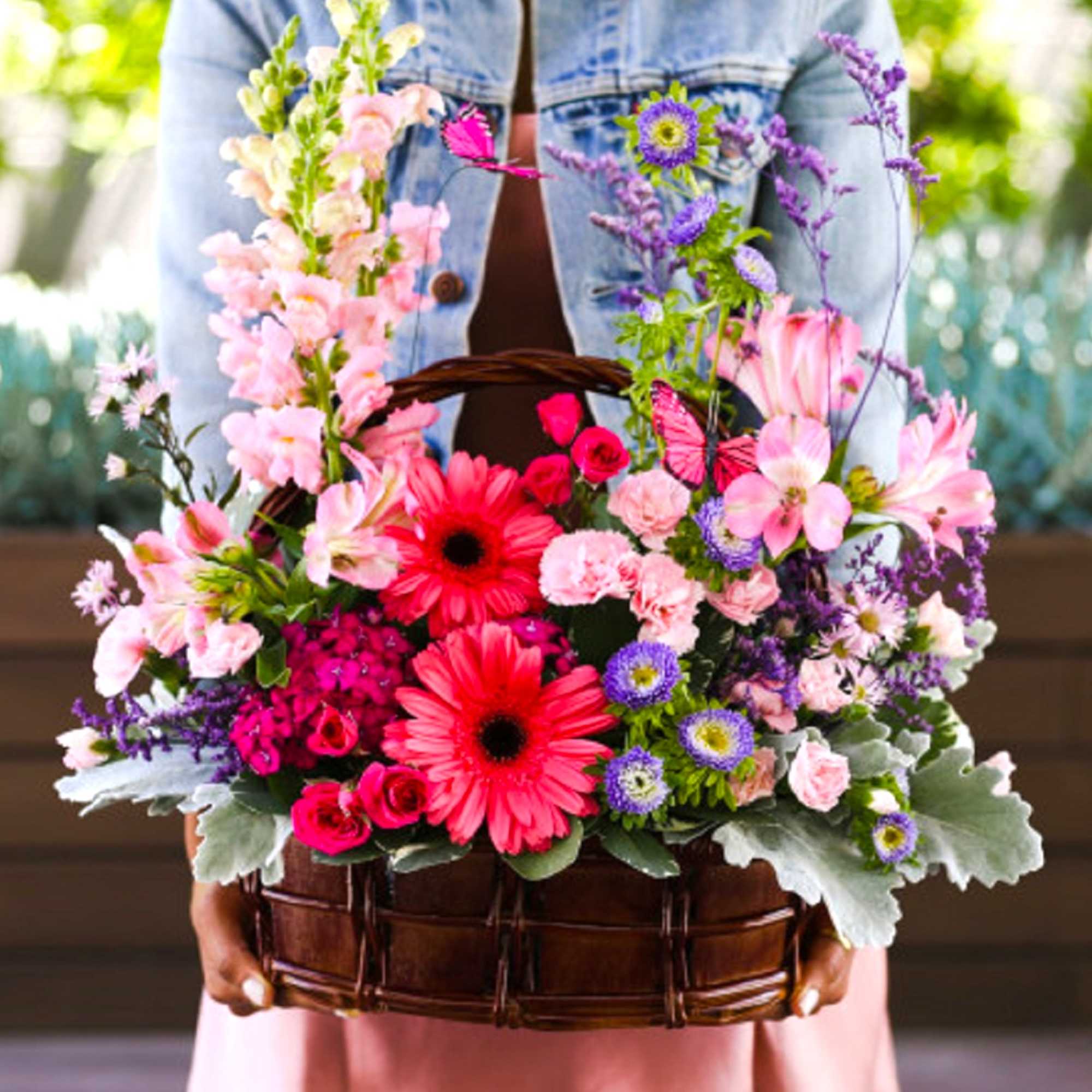 Basket of pink and purple flowers with two bright gerbera daisies