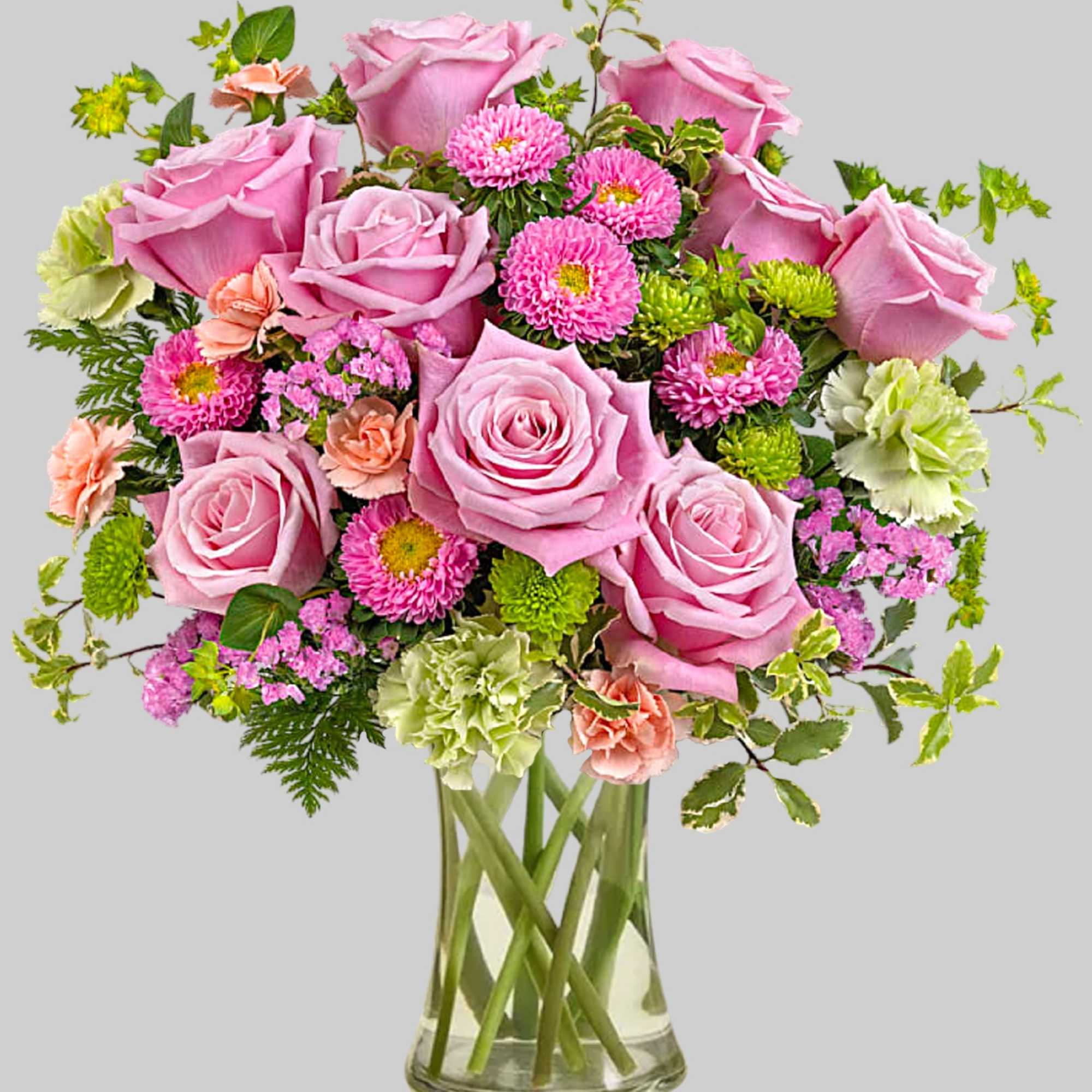 Pink roses and mixed flowers arranged in a clear glass vase, photo 2 of 4