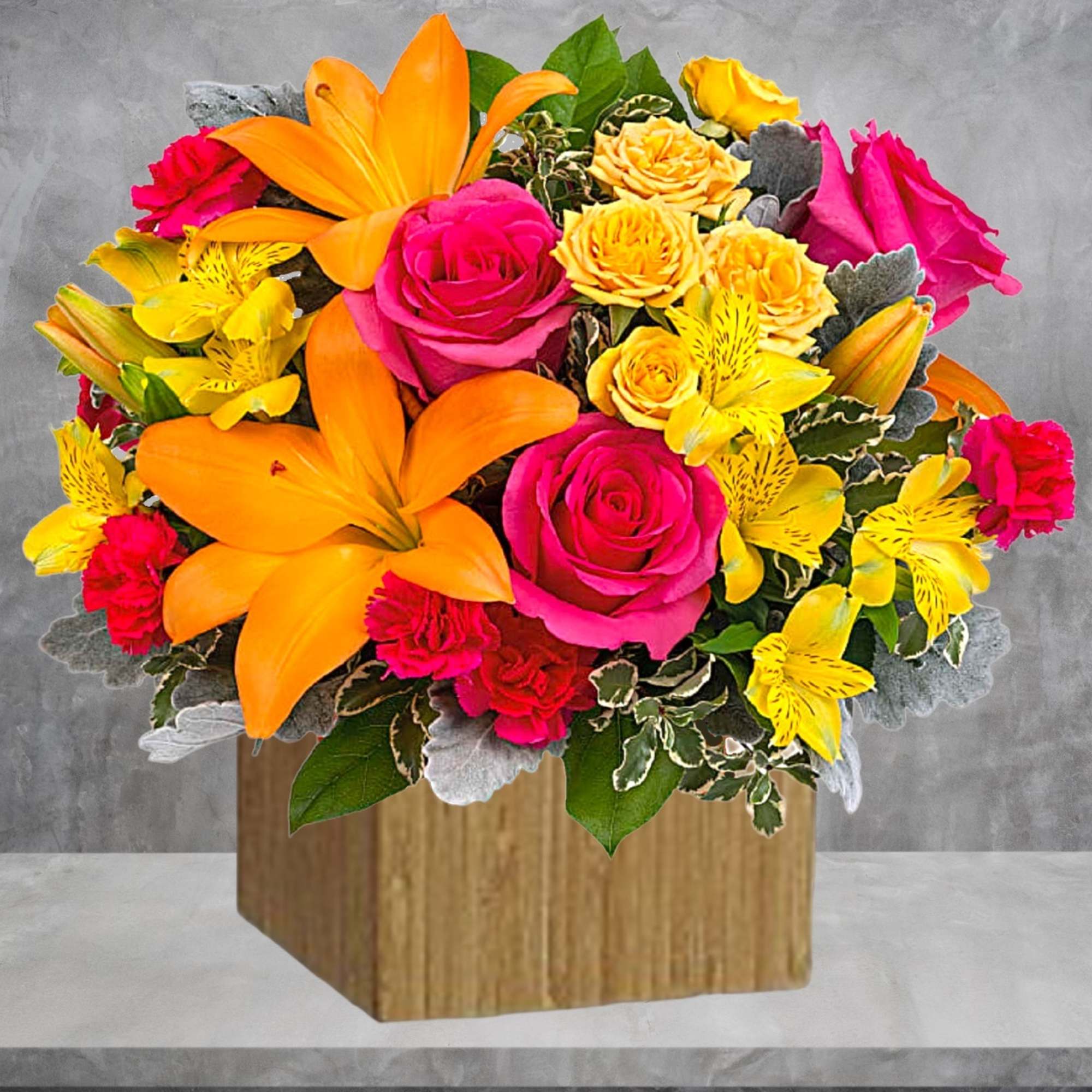 Bright mixed bouquet with roses, lilies, and yellow alstroemeria in a wooden box