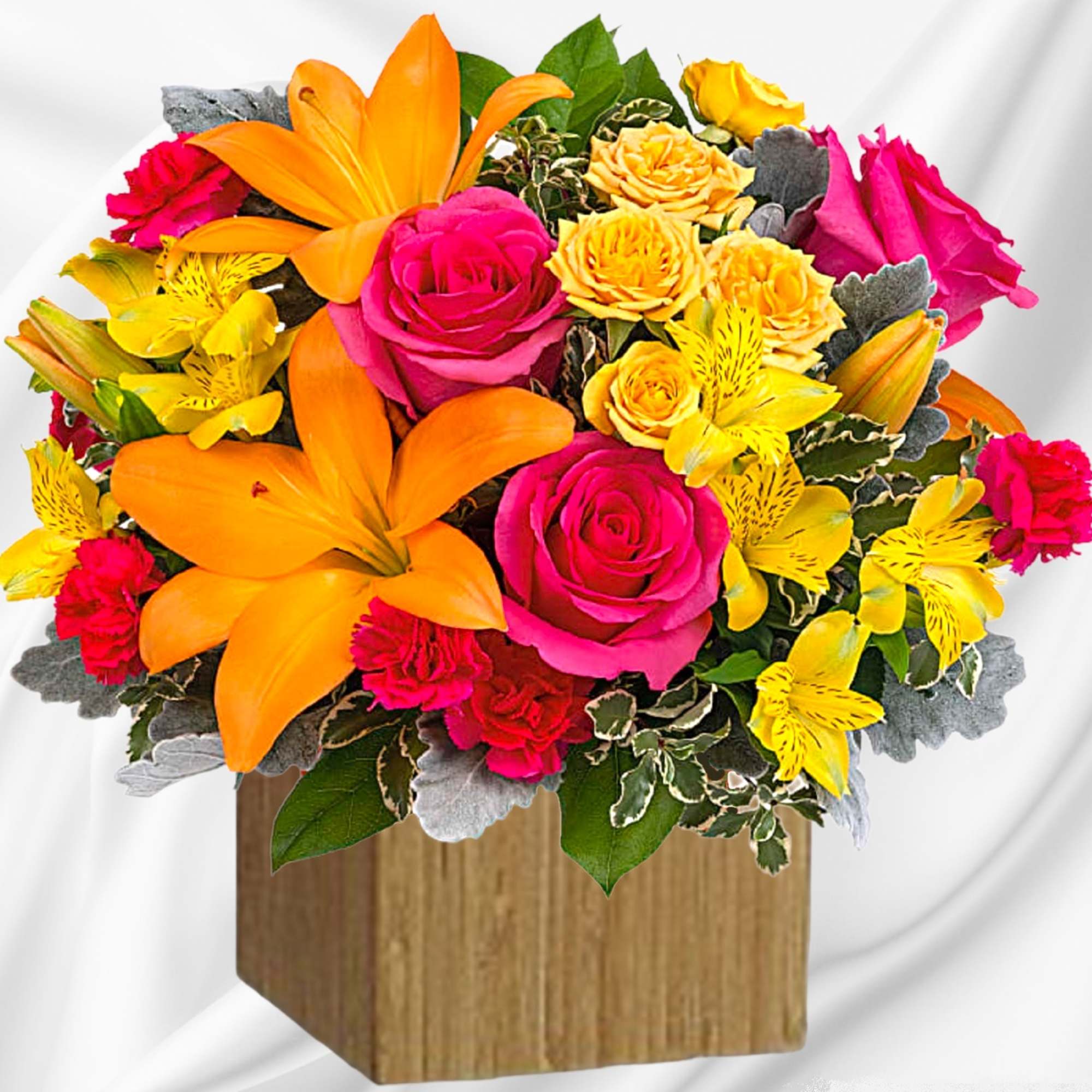 Bright bouquet of pink roses, orange lilies, and yellow flowers in a wooden box