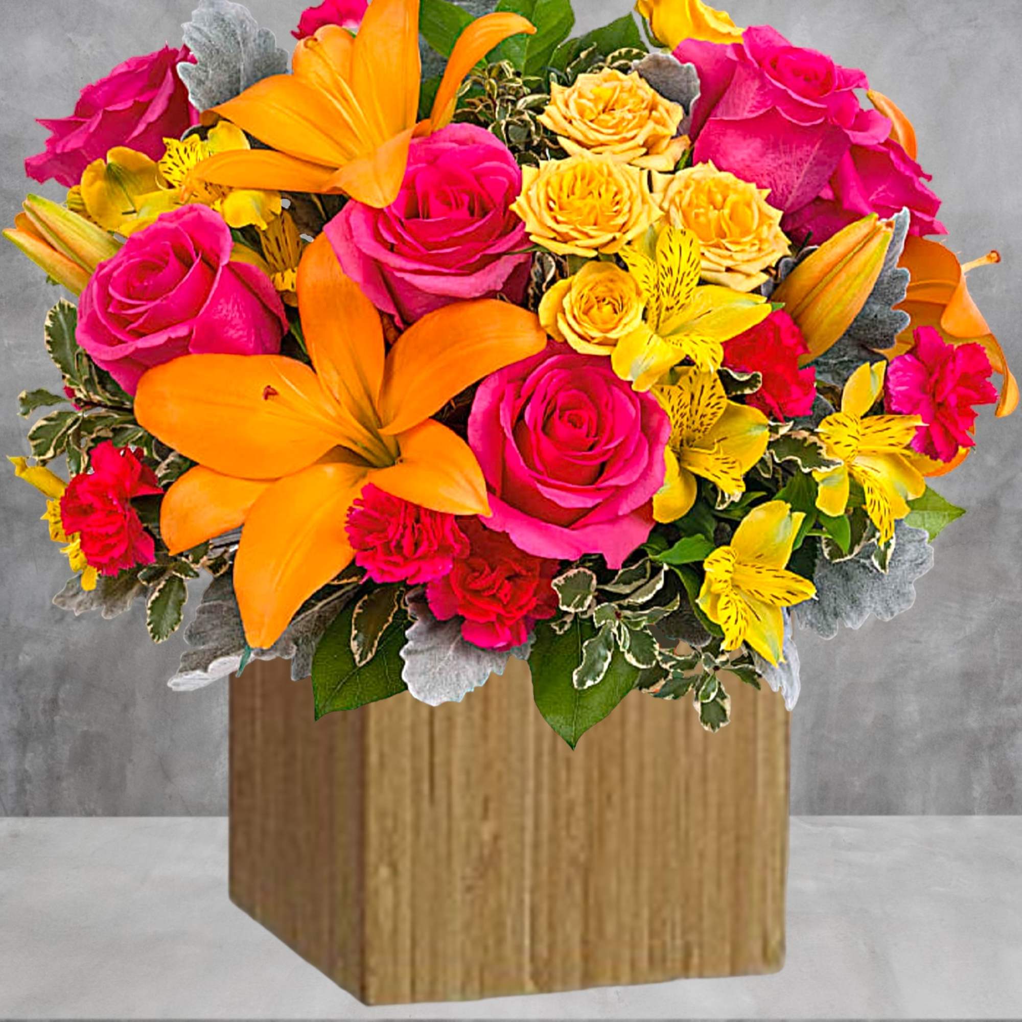 Bright bouquet of pink roses, orange lilies, and yellow flowers in a wooden cube vase, photo 3 of 4