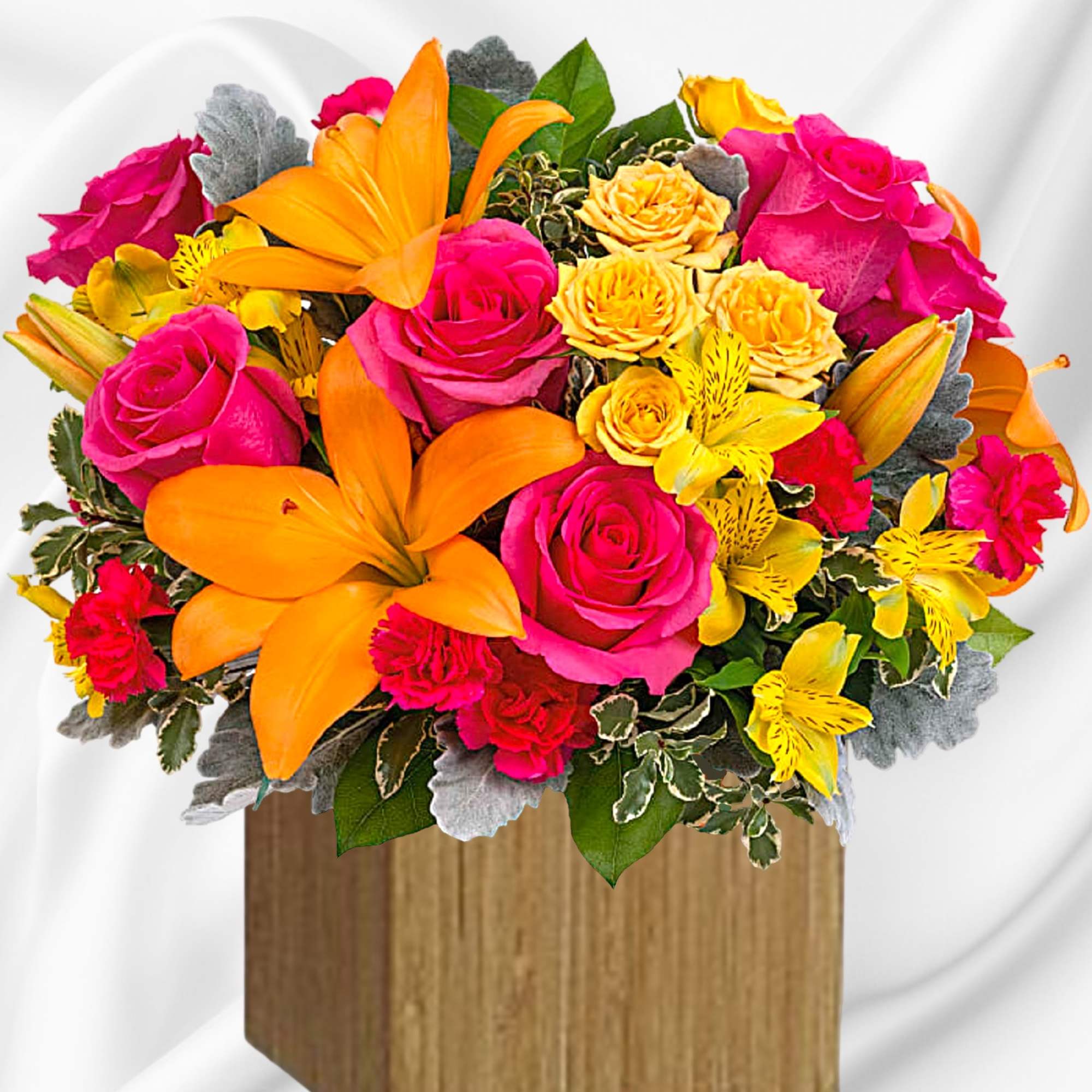 Bright bouquet of pink and yellow flowers in a wooden box