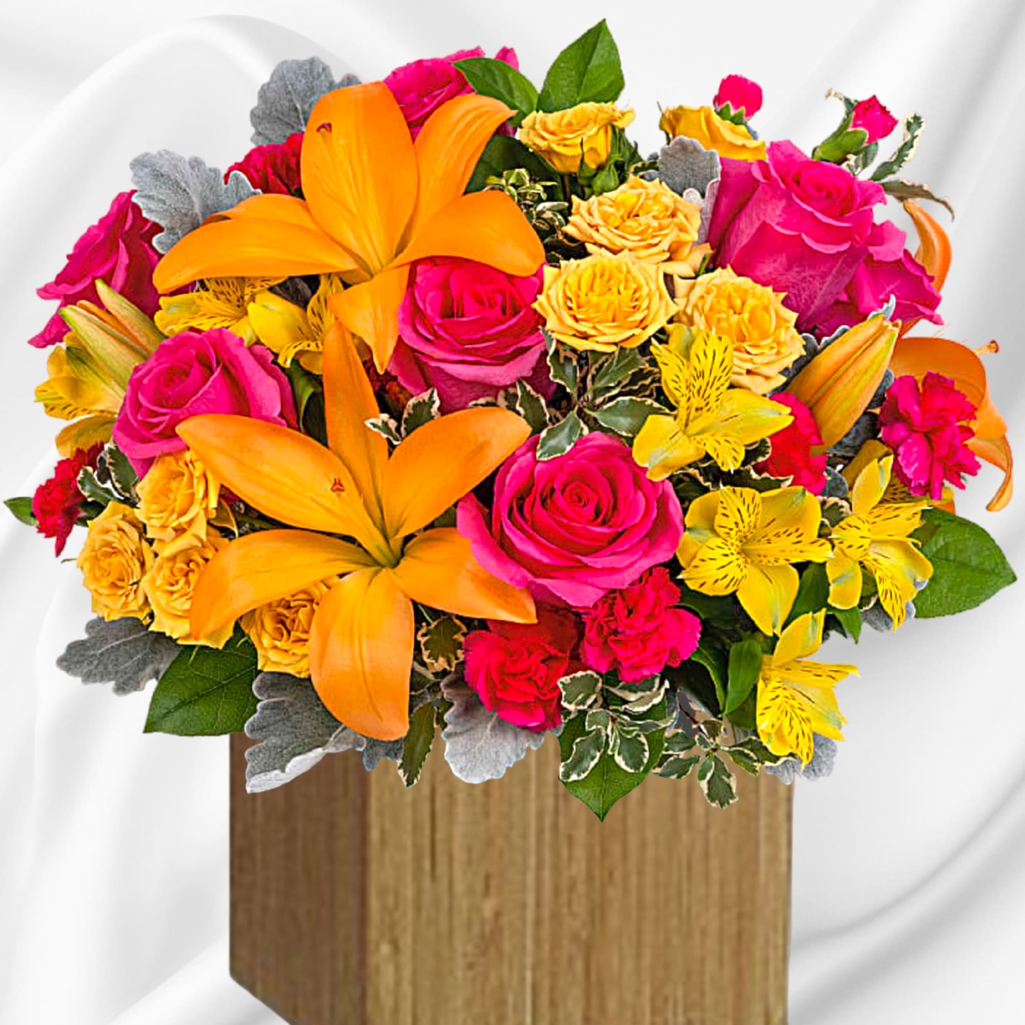 Bouquet of orange lilies, pink roses, and yellow flowers in a wooden box