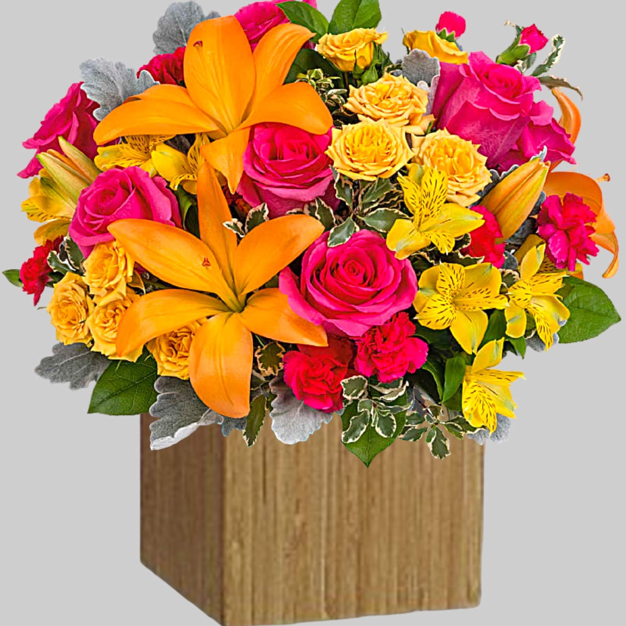 Bright mixed bouquet with orange lilies and pink roses in a wooden box