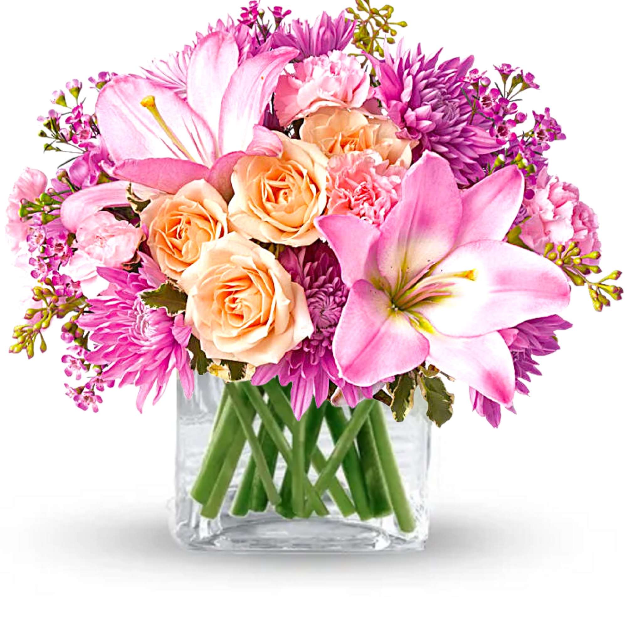 Pink and peach flowers arranged in a clear glass vase
