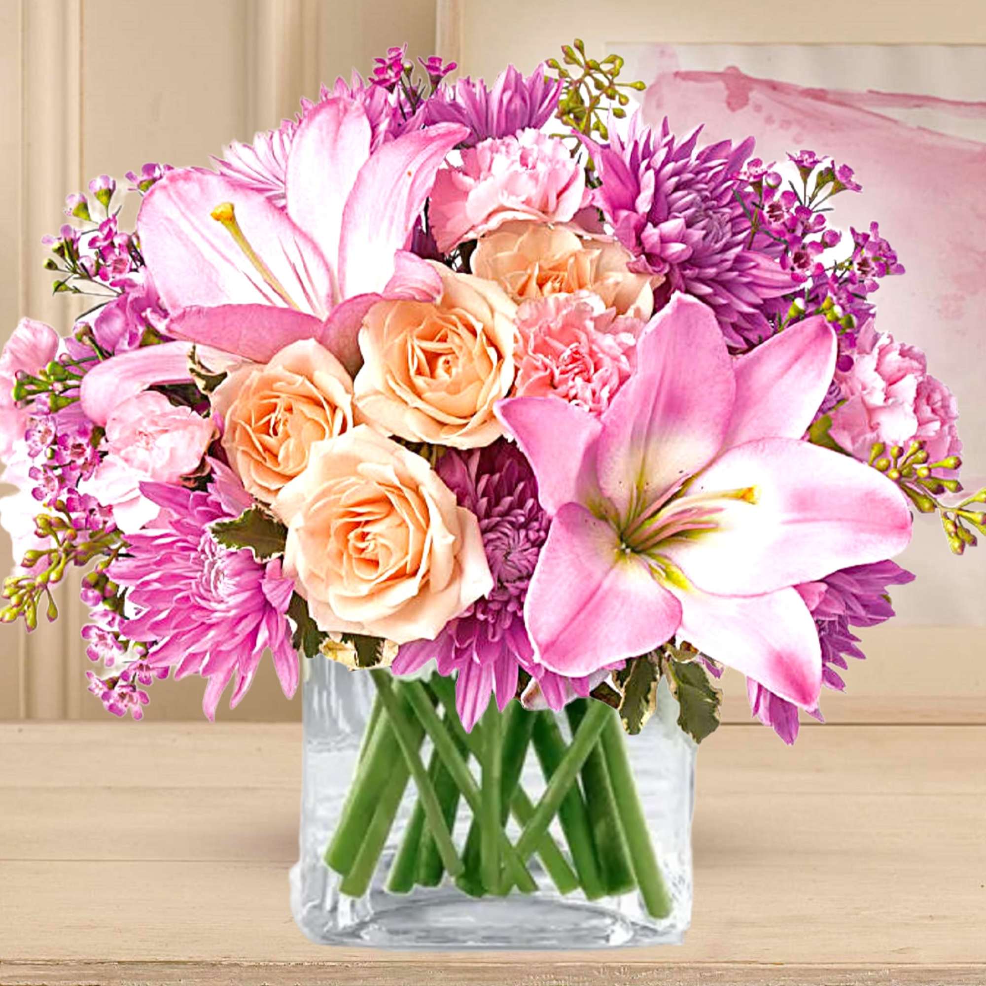 Pink and peach bouquet of lilies, roses, and chrysanthemums in a clear glass vase, photo 3 of 5