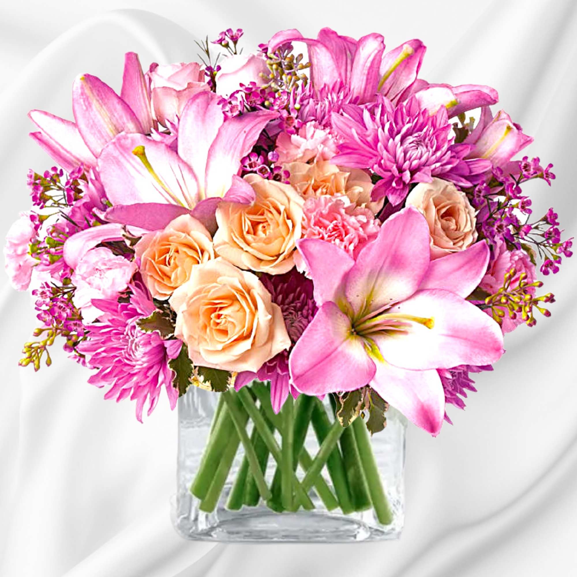Pink lilies and peach roses arranged in a clear glass vase, photo 4 of 5