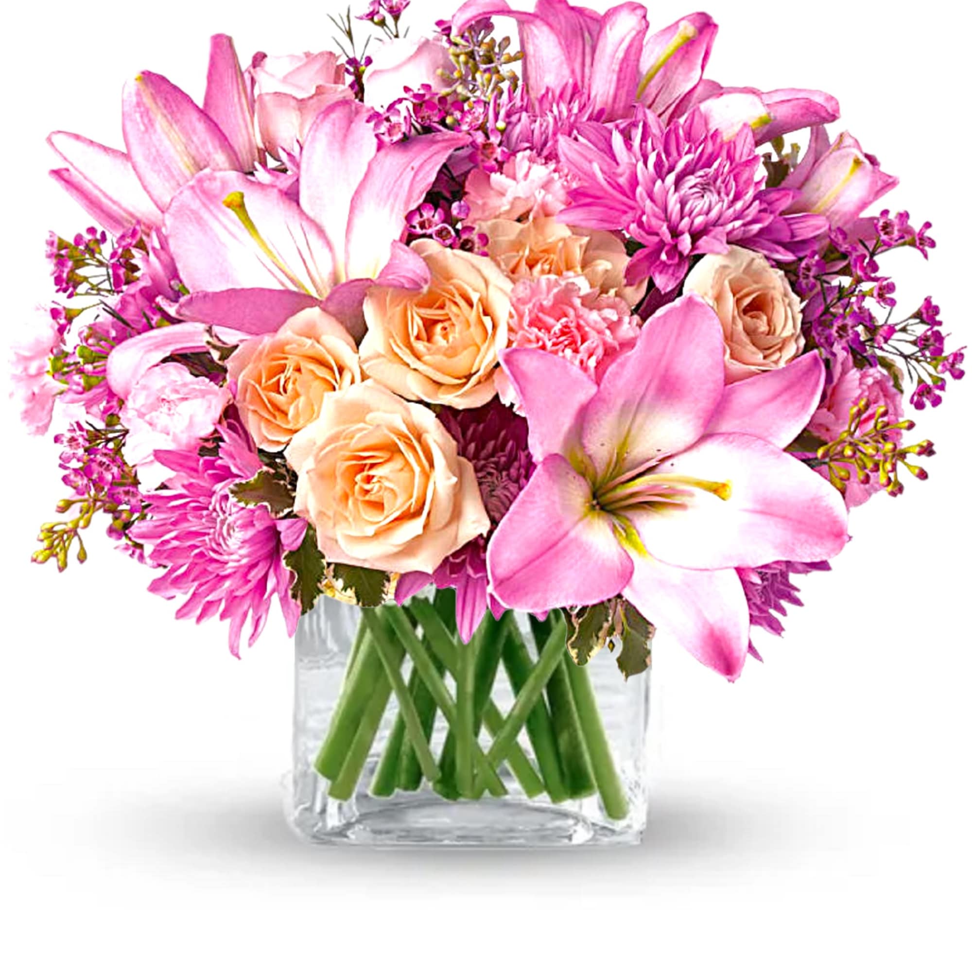 Pink lilies and peach roses arranged in a clear glass vase