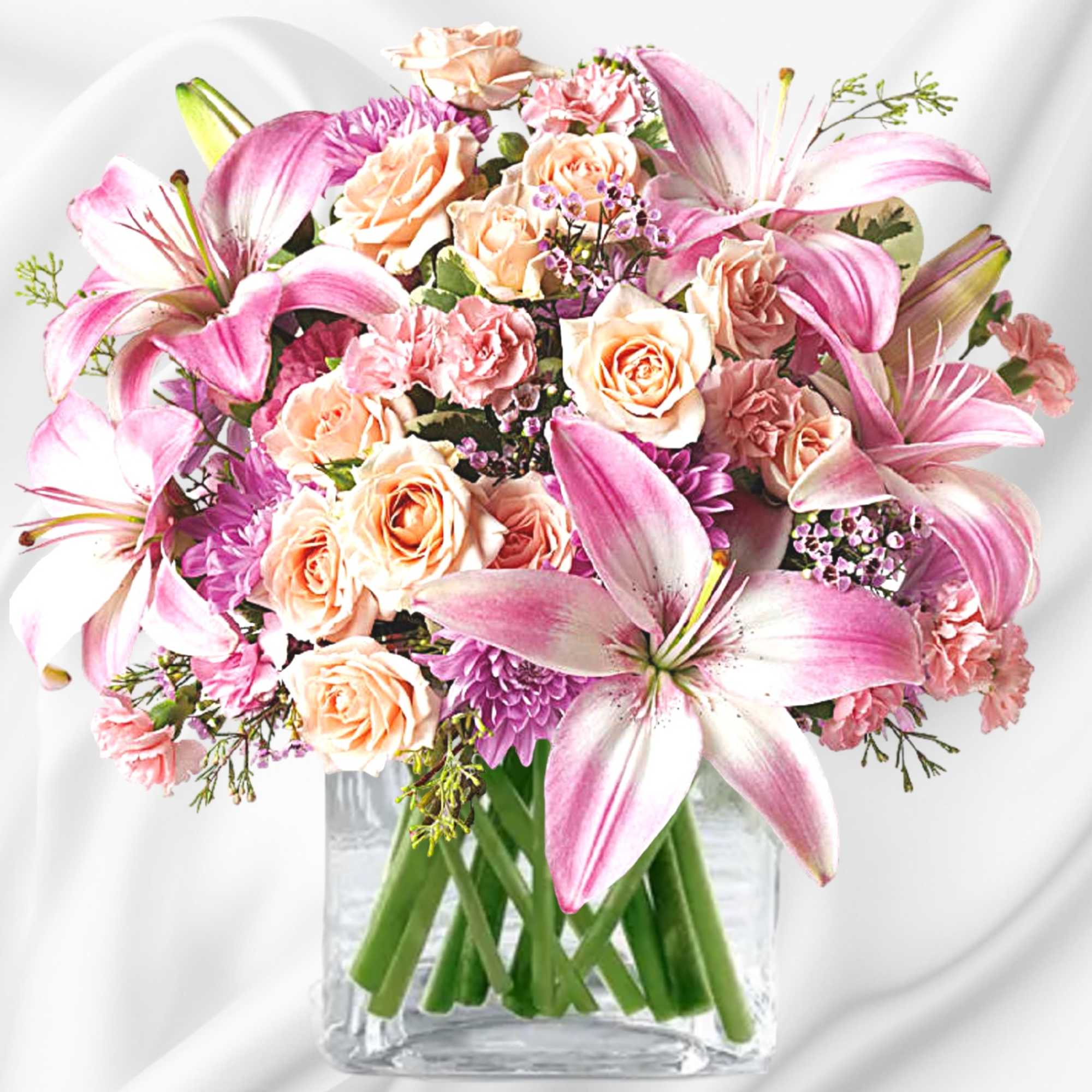 Pink lilies and peach roses arranged in a clear glass vase, photo 4 of 5