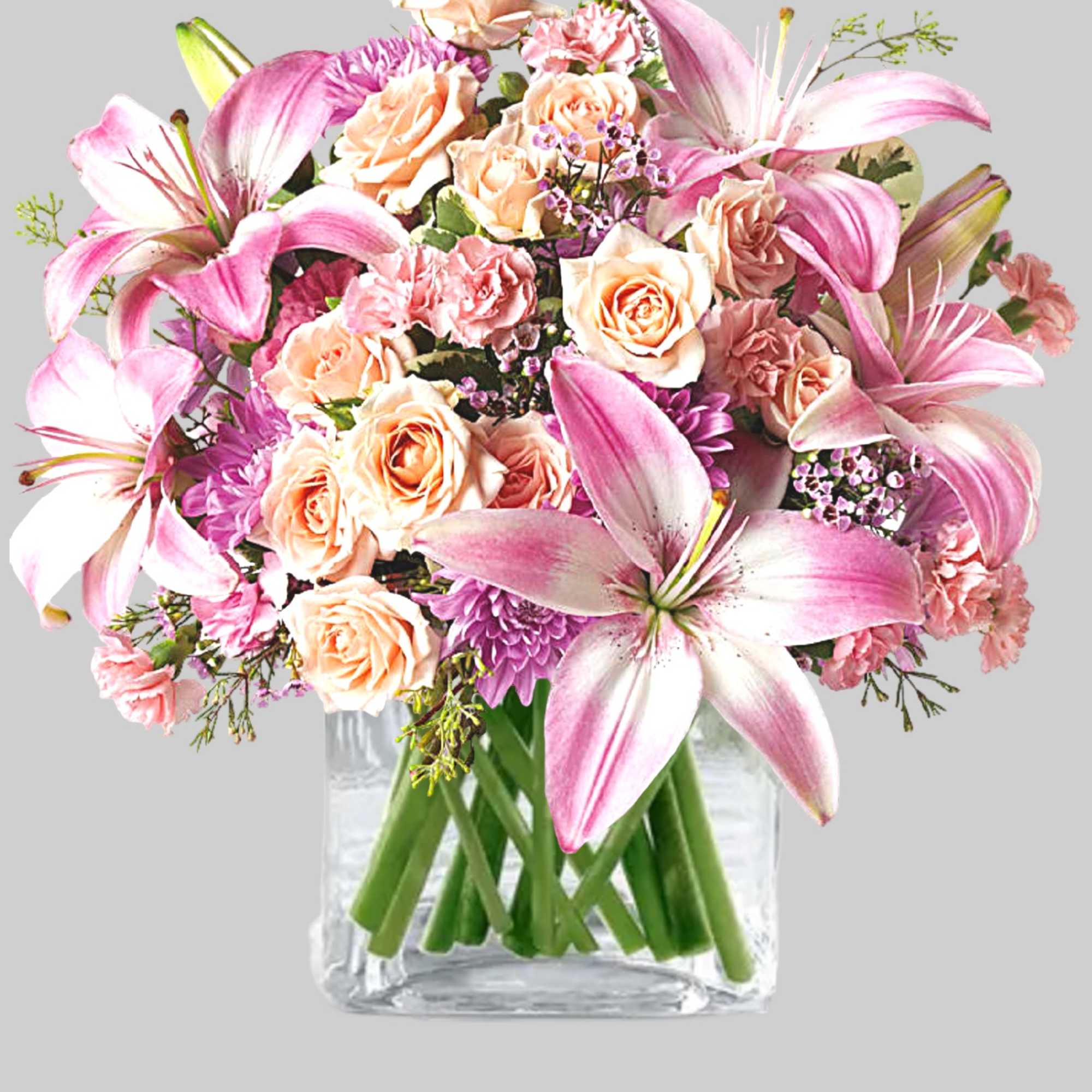 Pink lilies and peach roses arranged in a clear glass vase, photo 5 of 5