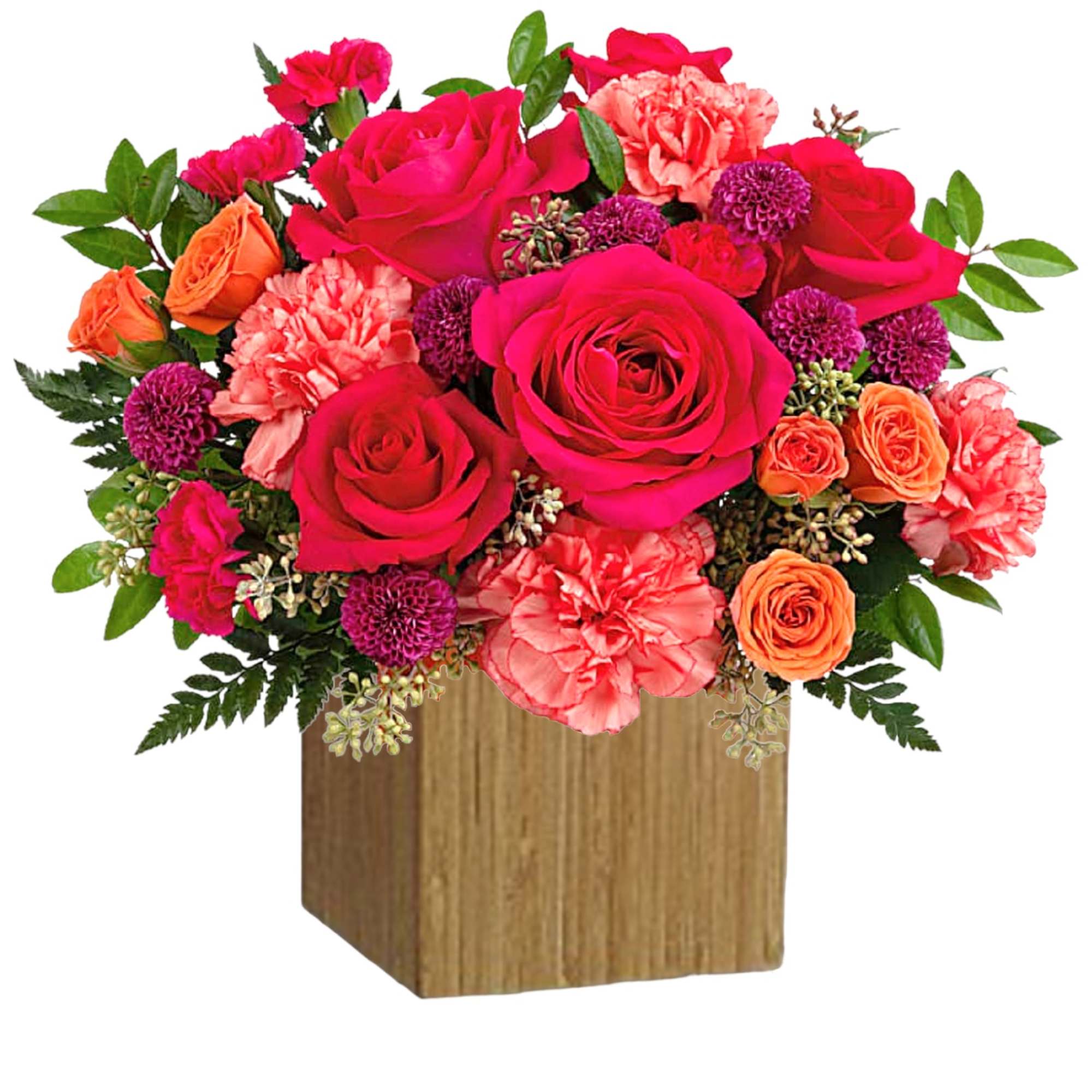 Bouquet of pink and orange roses with carnations in a wooden cube vase