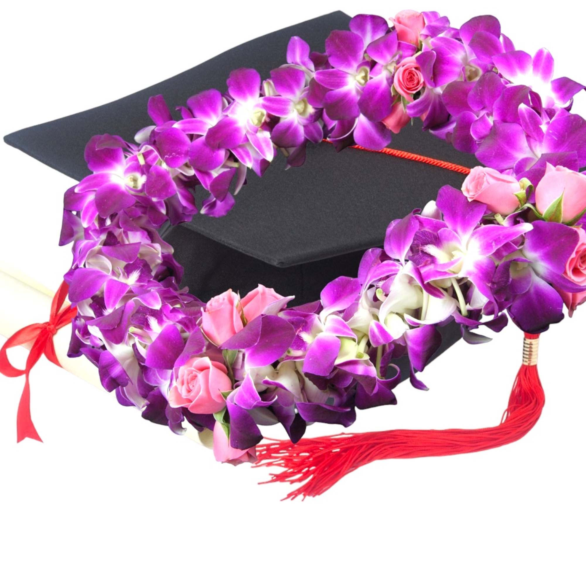 Purple orchid and pink rose lei draped over a graduation cap