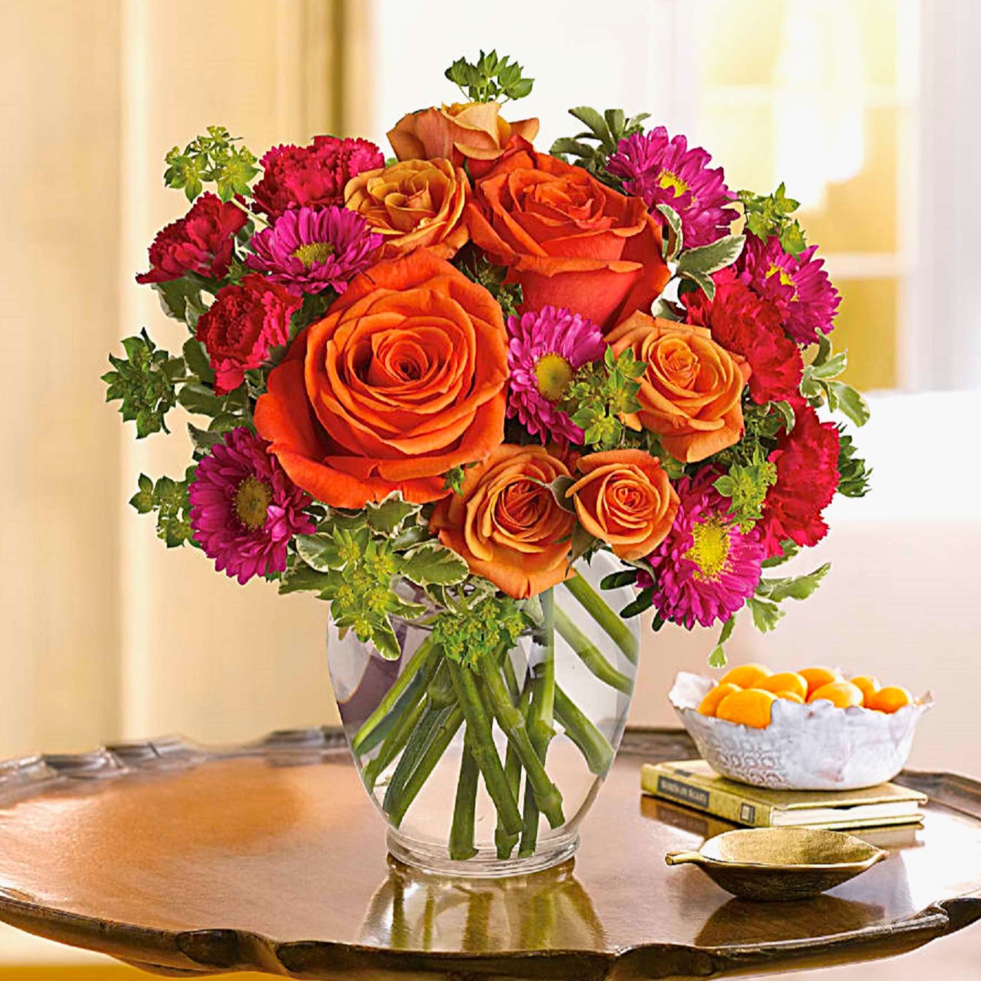 Orange roses and magenta daisies in a clear glass vase, photo 3 of 5