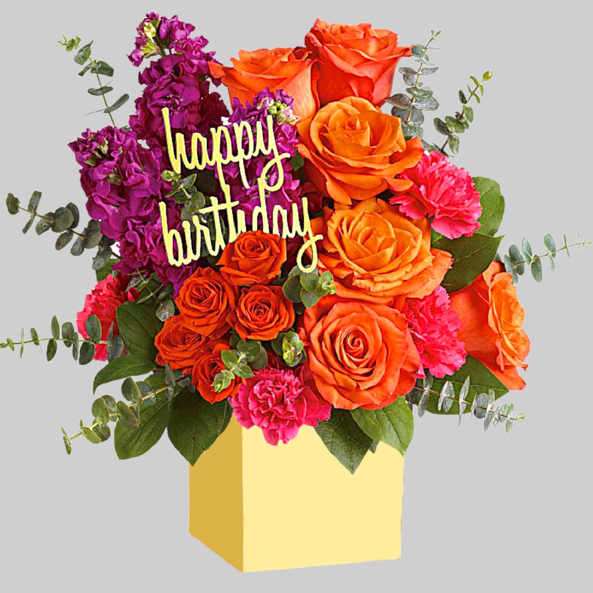 Birthday bouquet of orange roses and pink flowers in a yellow box