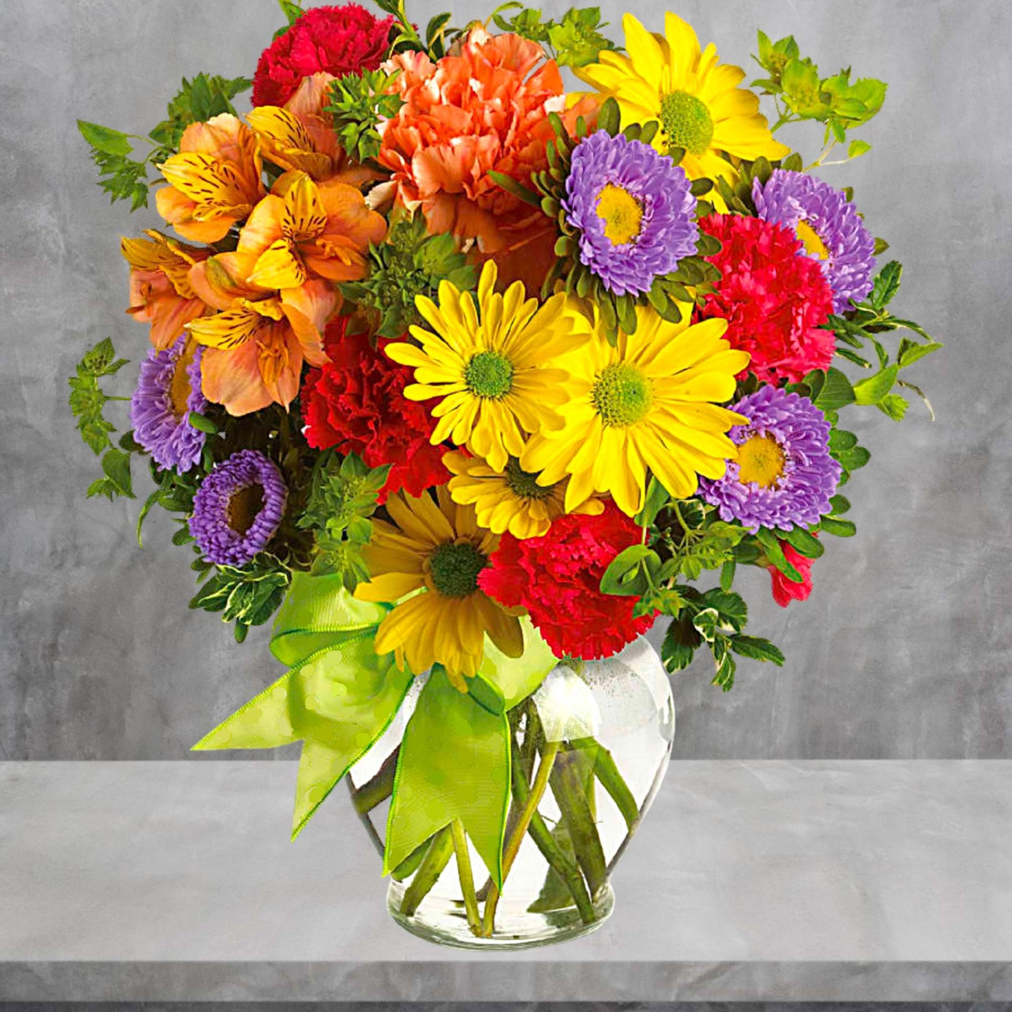Colorful mixed bouquet in a clear glass vase with a green ribbon, photo 2 of 5