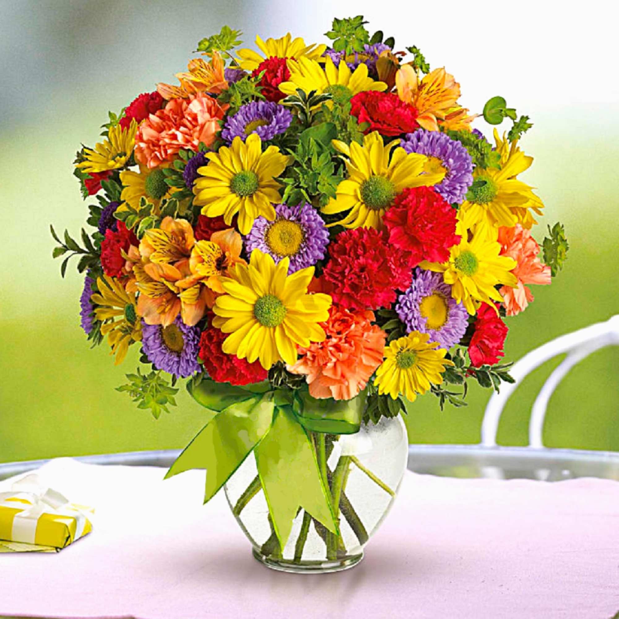 Colorful mixed bouquet in a clear glass vase with a green ribbon, photo 3 of 6