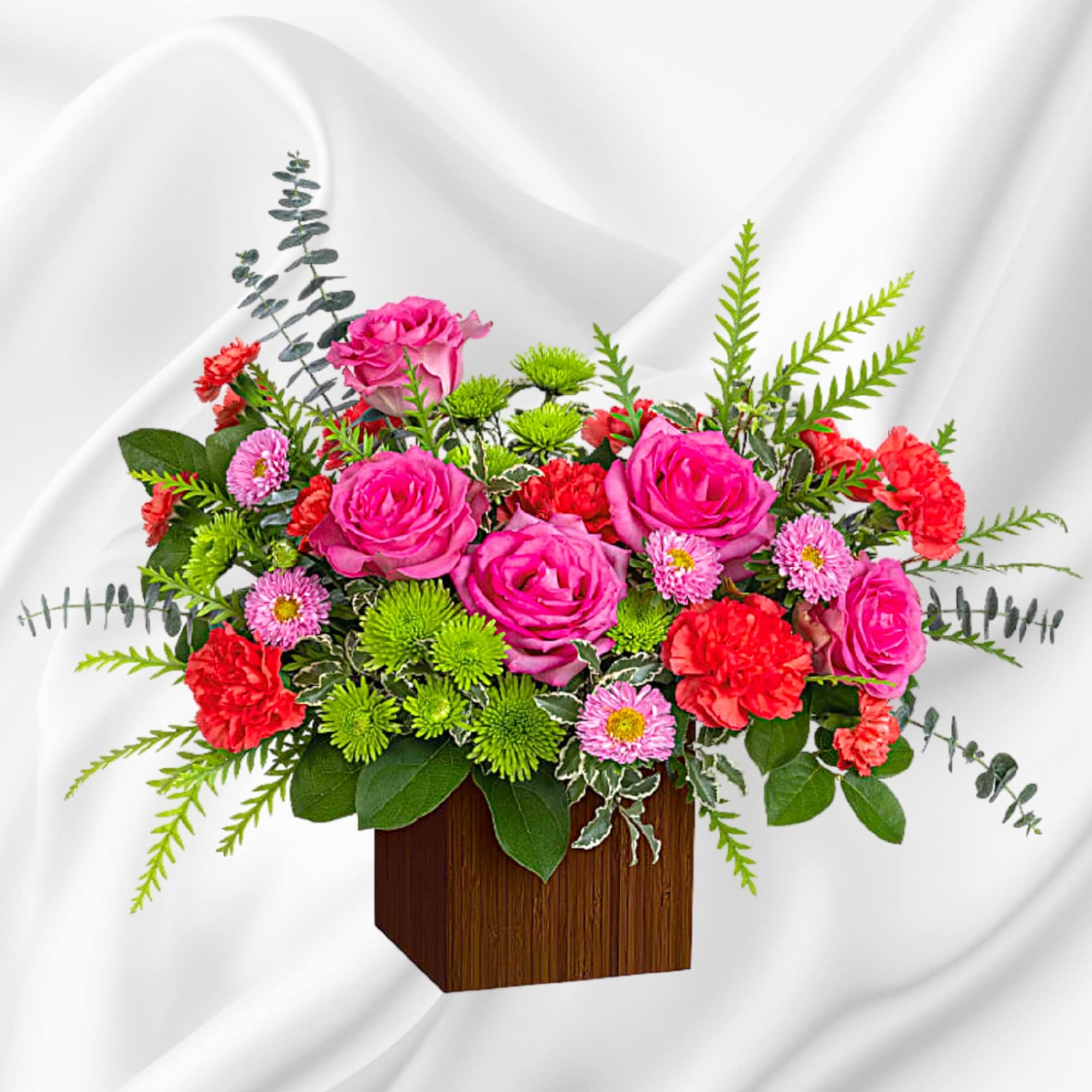 Pink roses and red carnations in a wooden box arrangement