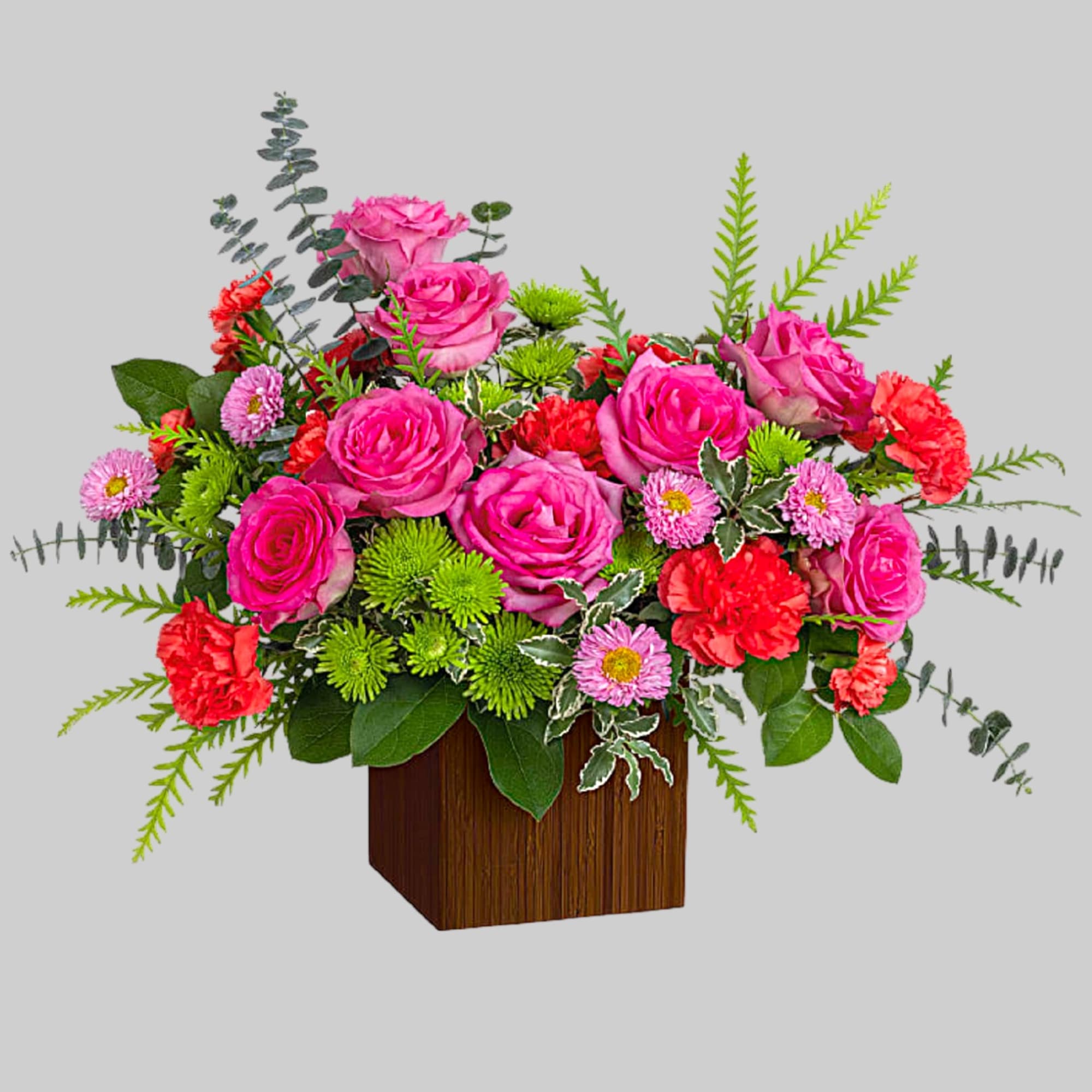 Pink roses and carnations in a wooden cube vase