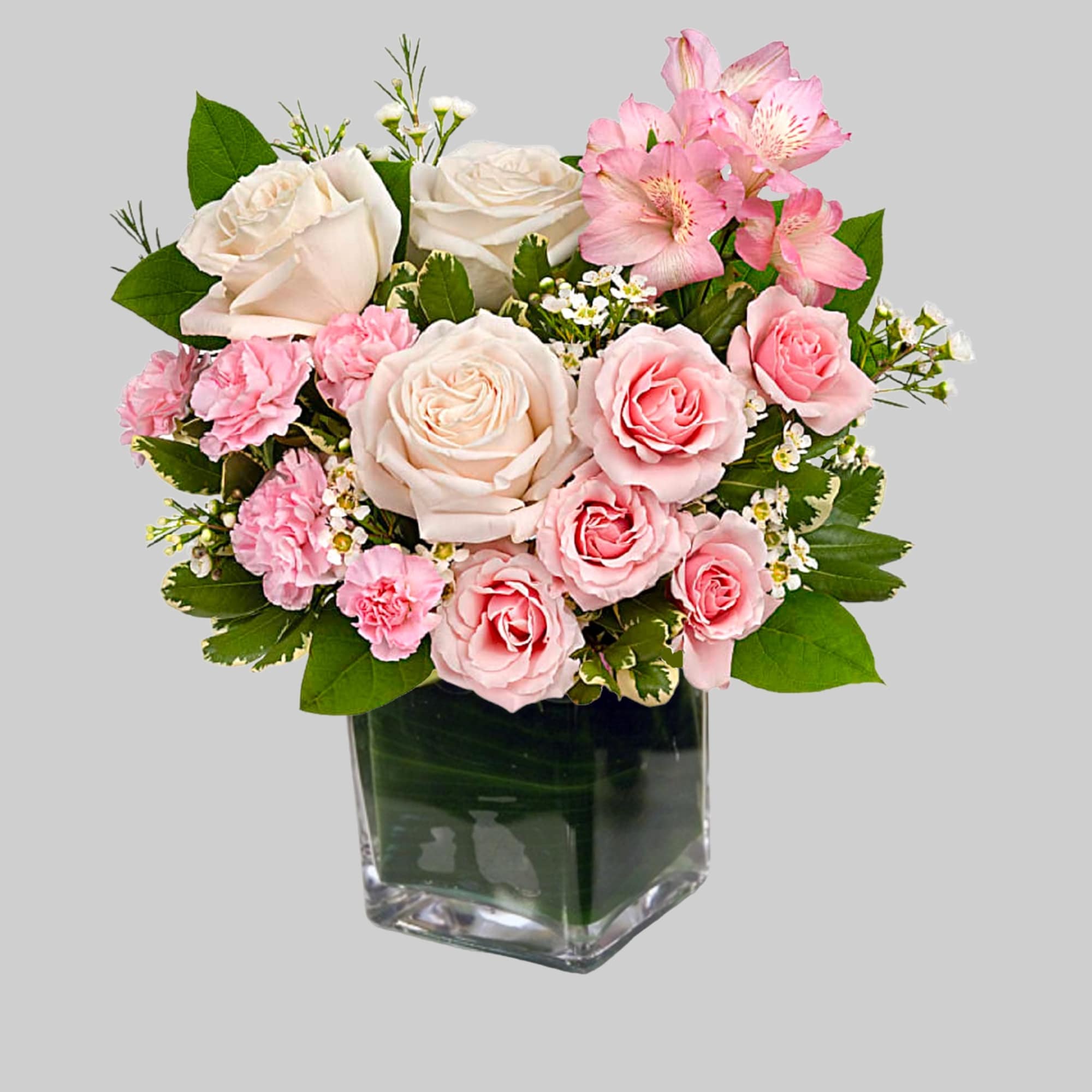 Pink and white roses arranged in a clear glass vase, photo 4 of 4