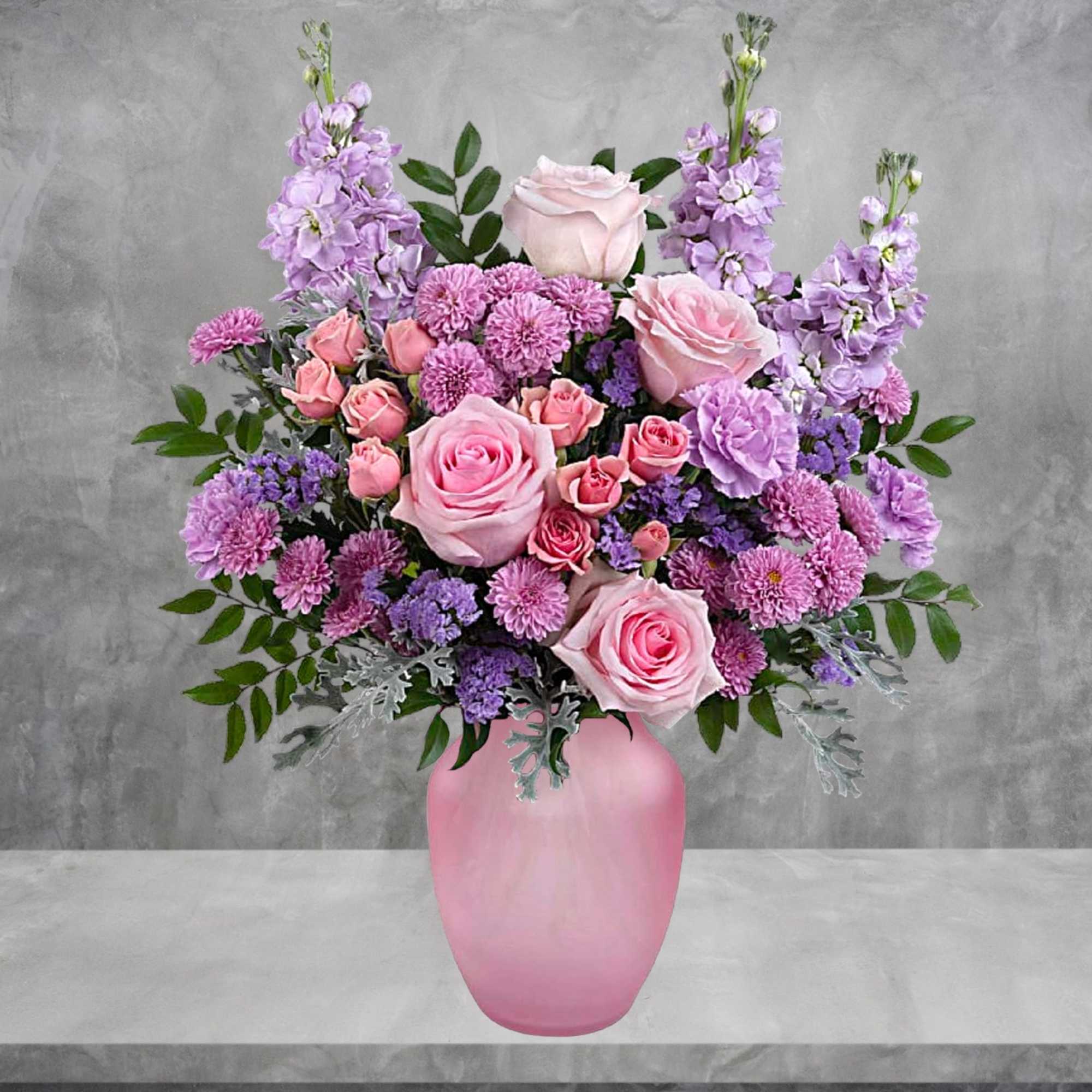 Pink and lavender floral arrangement in a pink vase