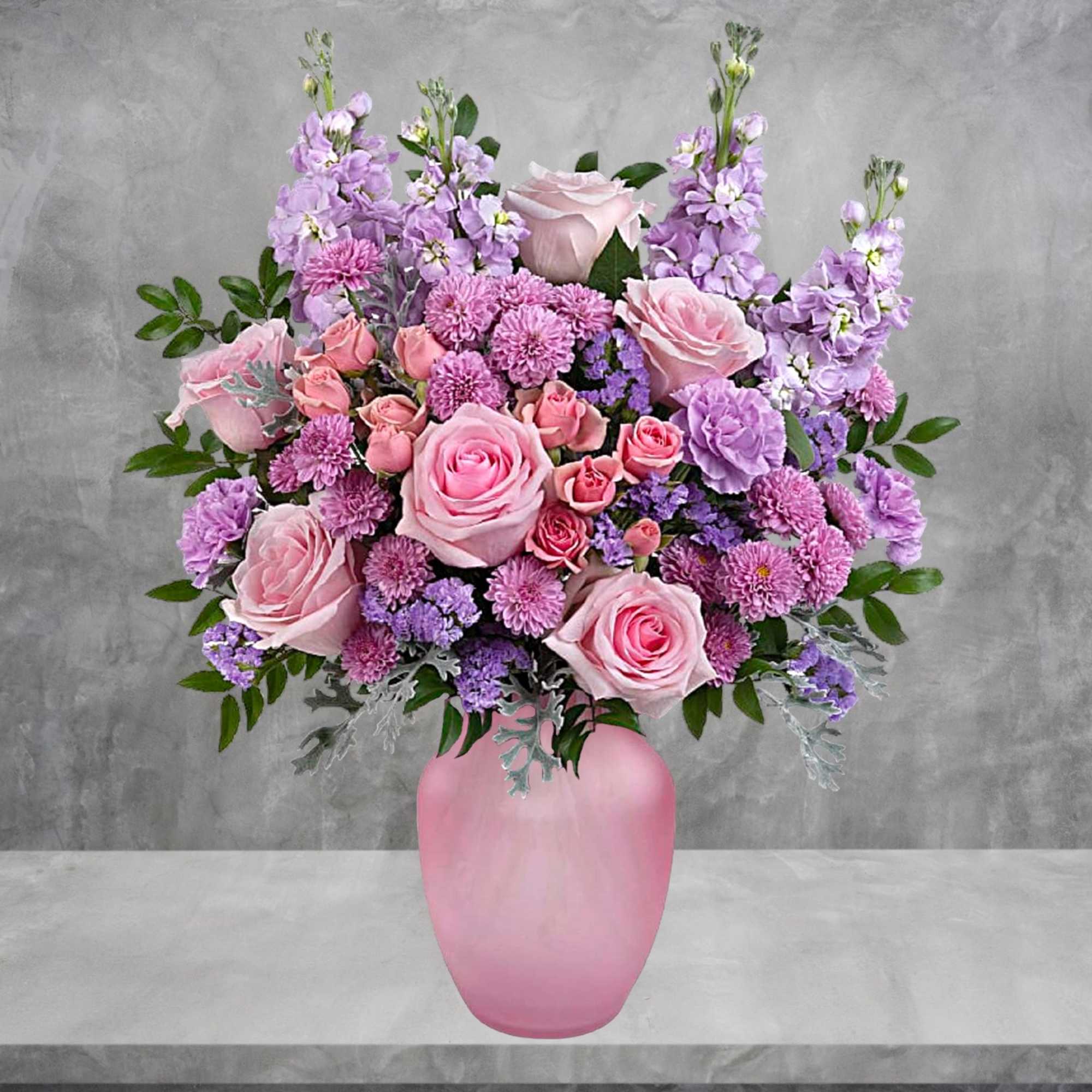 Pink and lavender floral arrangement in a pink vase