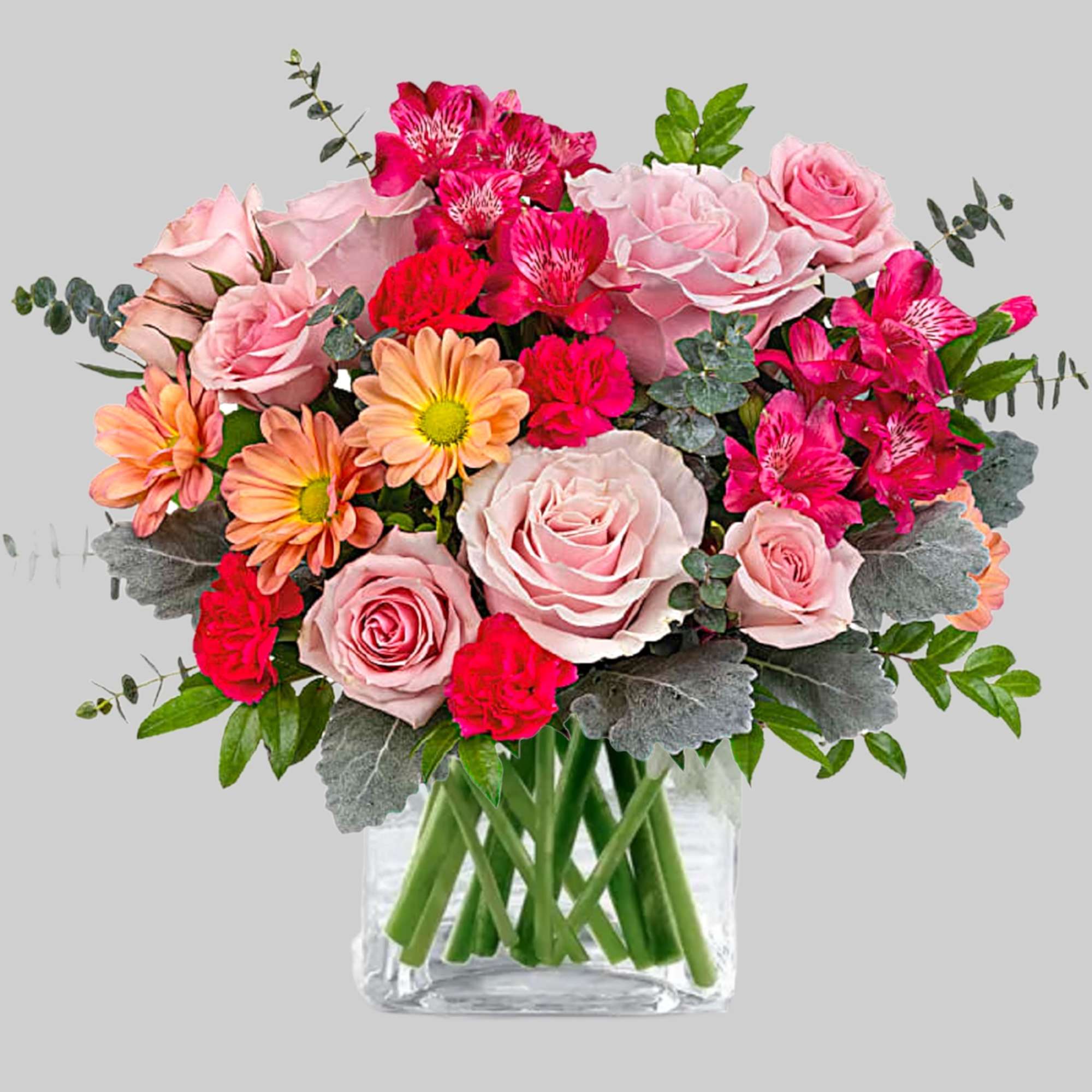 Pink roses and hot pink alstroemeria in a clear glass vase