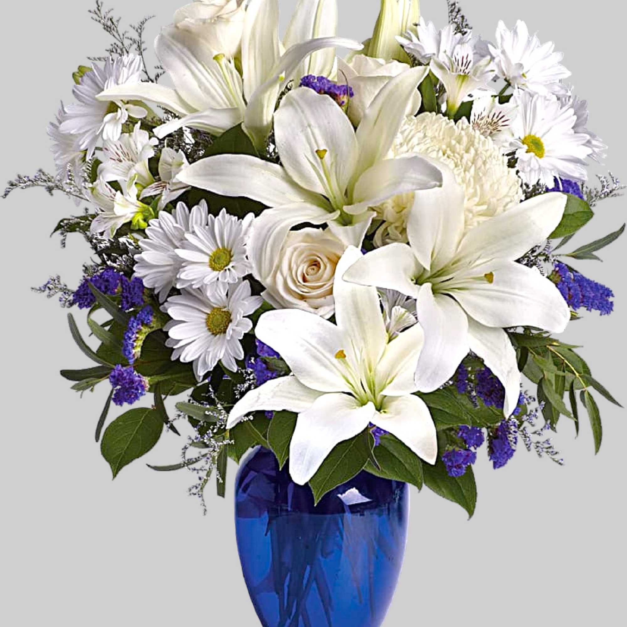 White lilies and daisies arranged in a blue glass vase, photo 4 of 4