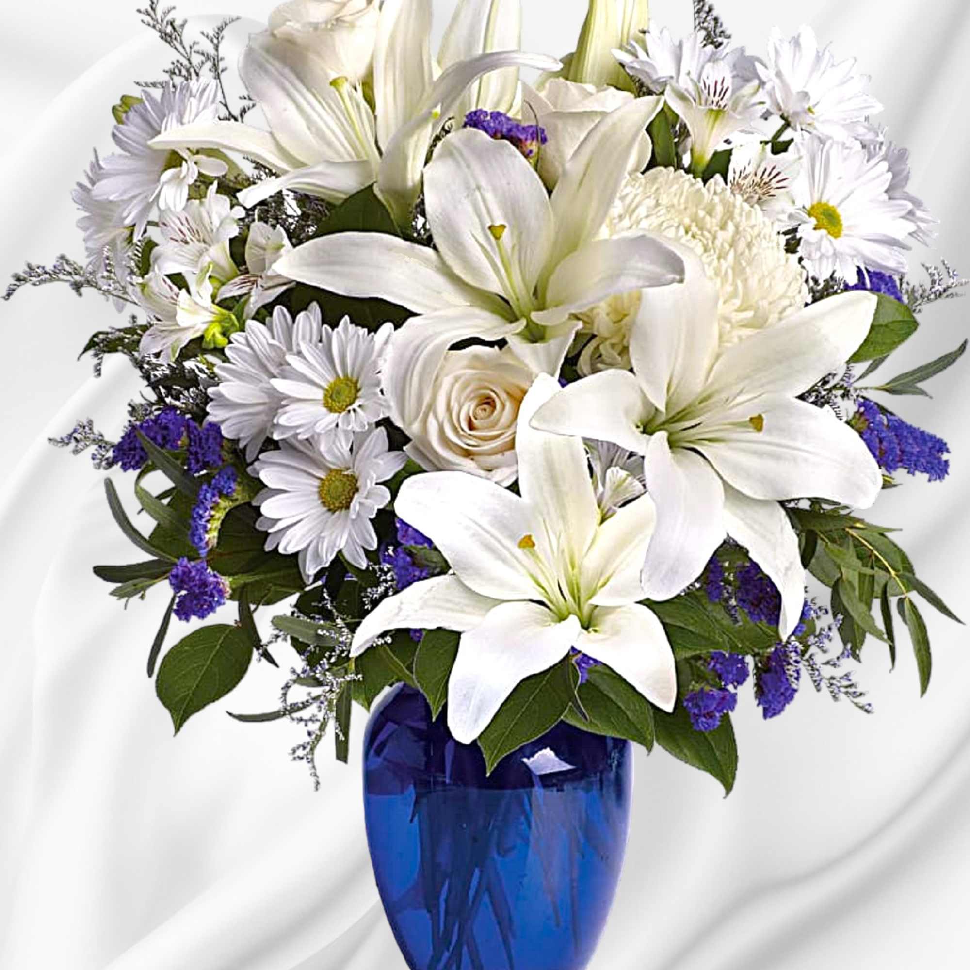 White lilies and daisies arranged in a blue vase, photo 2 of 4