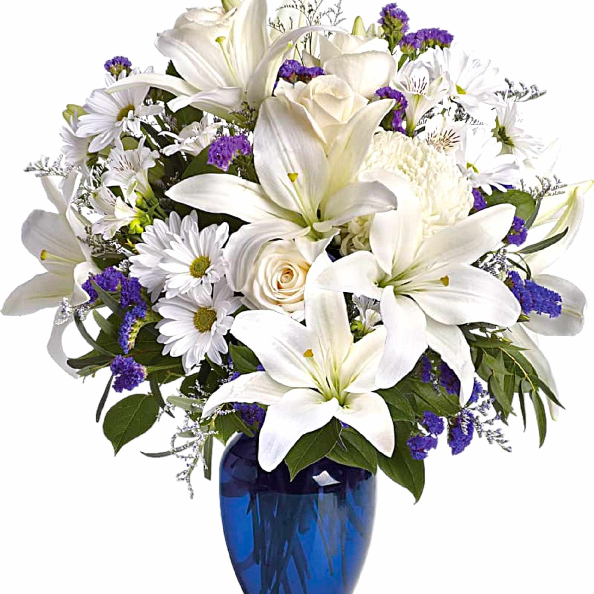 White lilies and daisies with purple accents in a blue glass vase