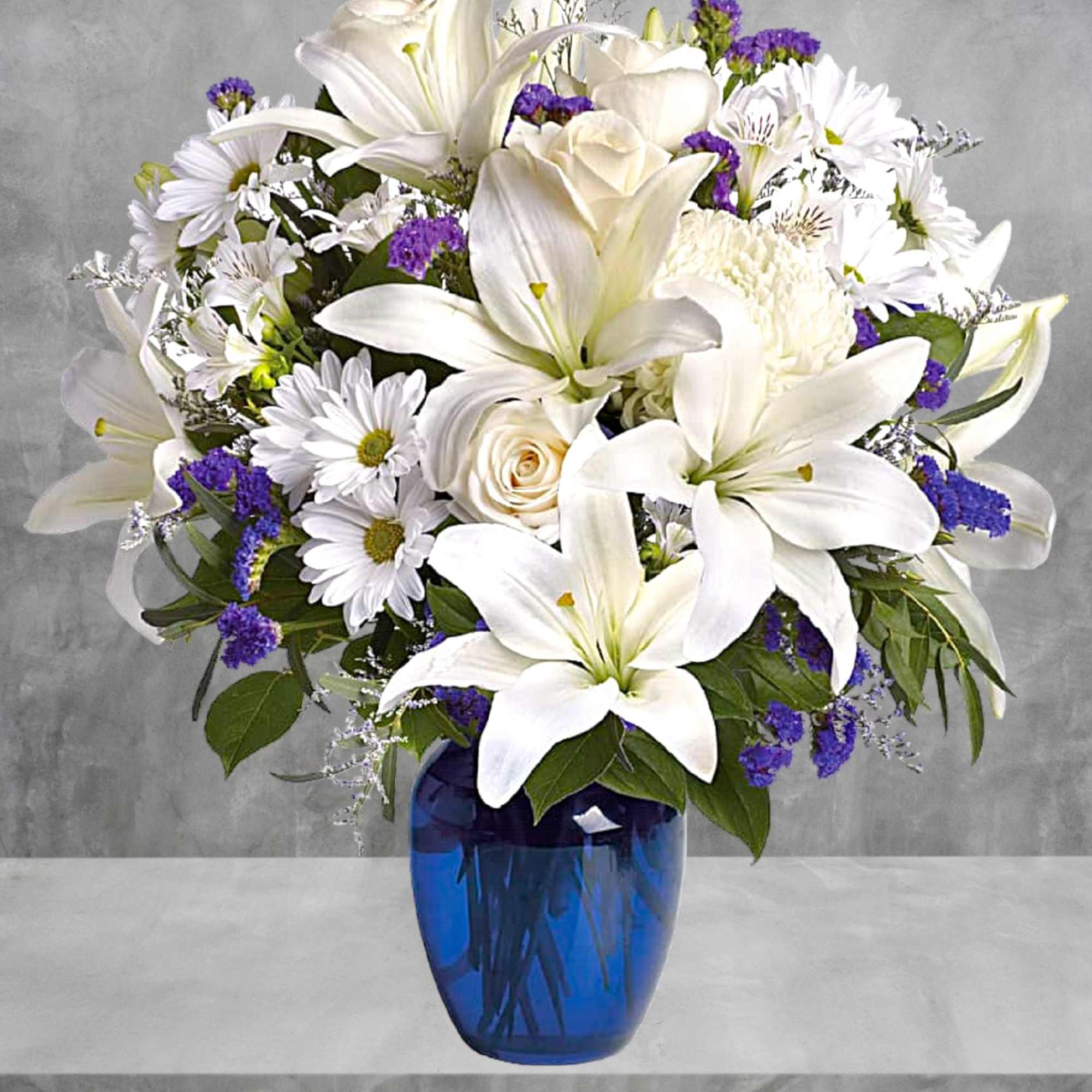 White lilies and daisies in a blue glass vase, photo 2 of 5