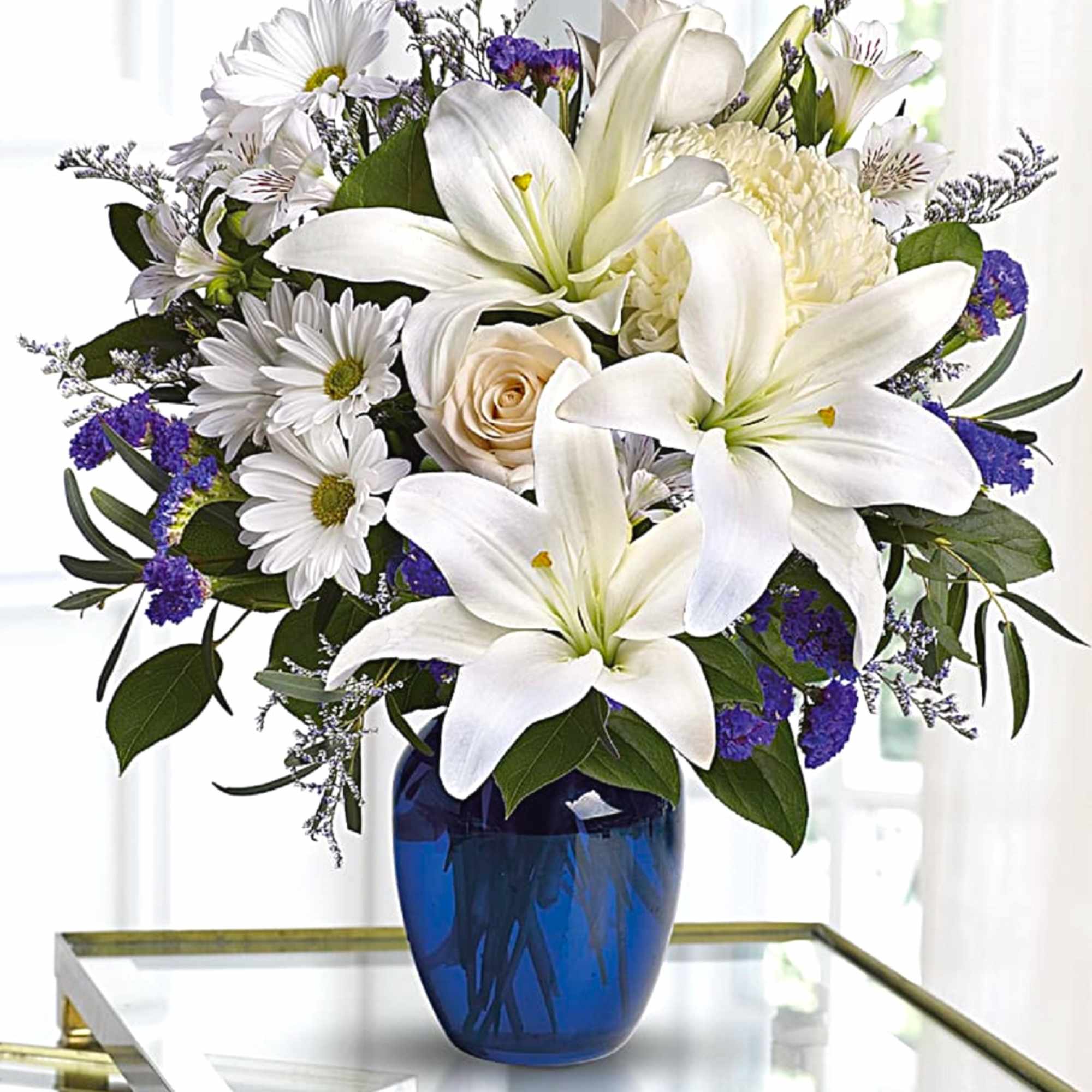 White lilies and daisies in a blue glass vase, photo 3 of 5