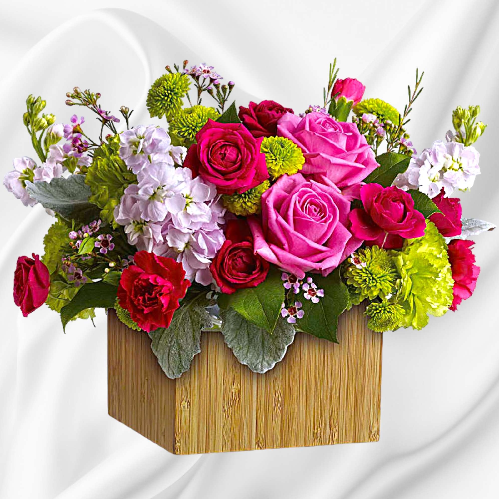Bright mixed bouquet of roses and mums in a wooden box
