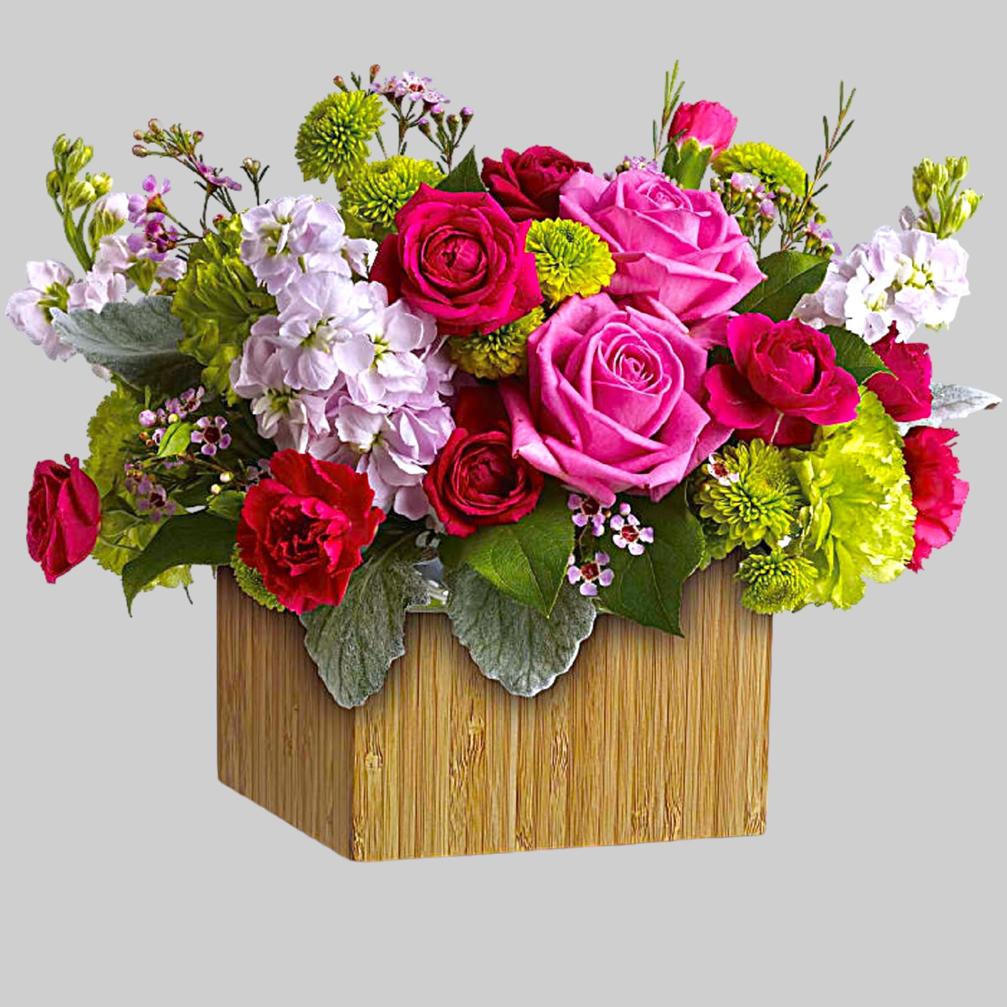 Bright mixed bouquet in a square wooden container