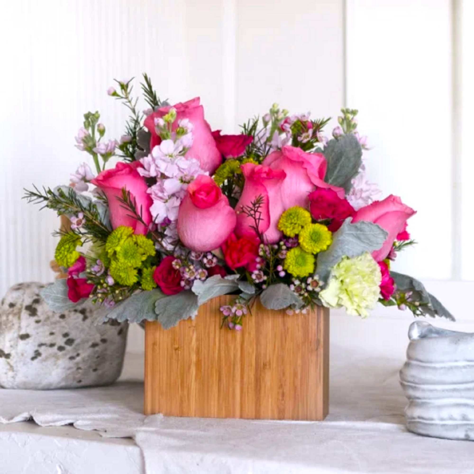 Pink roses and green button mums in a wooden box