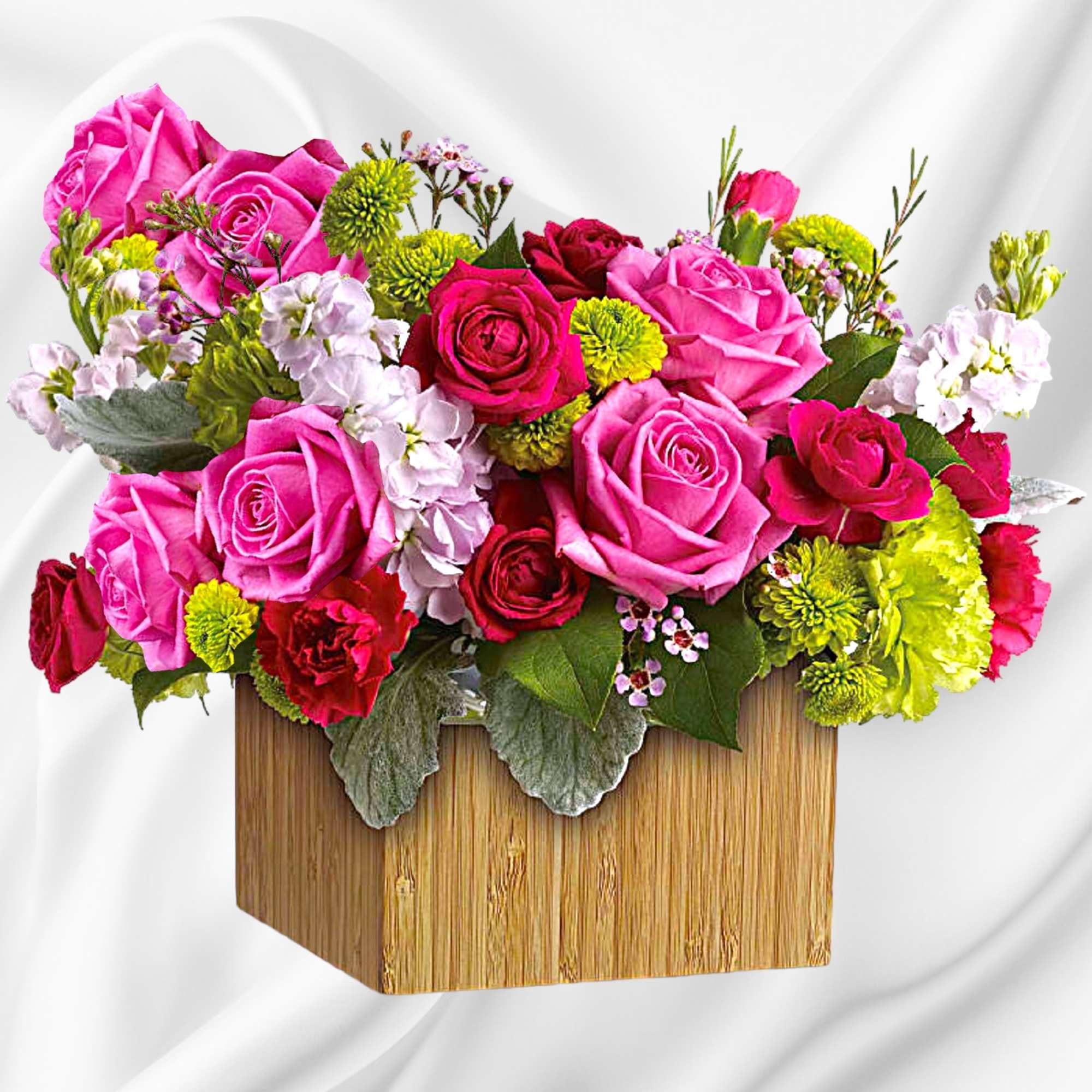 Pink and red rose arrangement in a wooden box