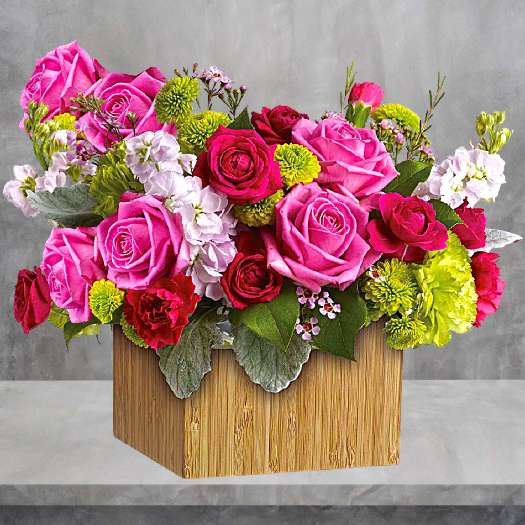 Pink and red roses with green mums in a wooden box