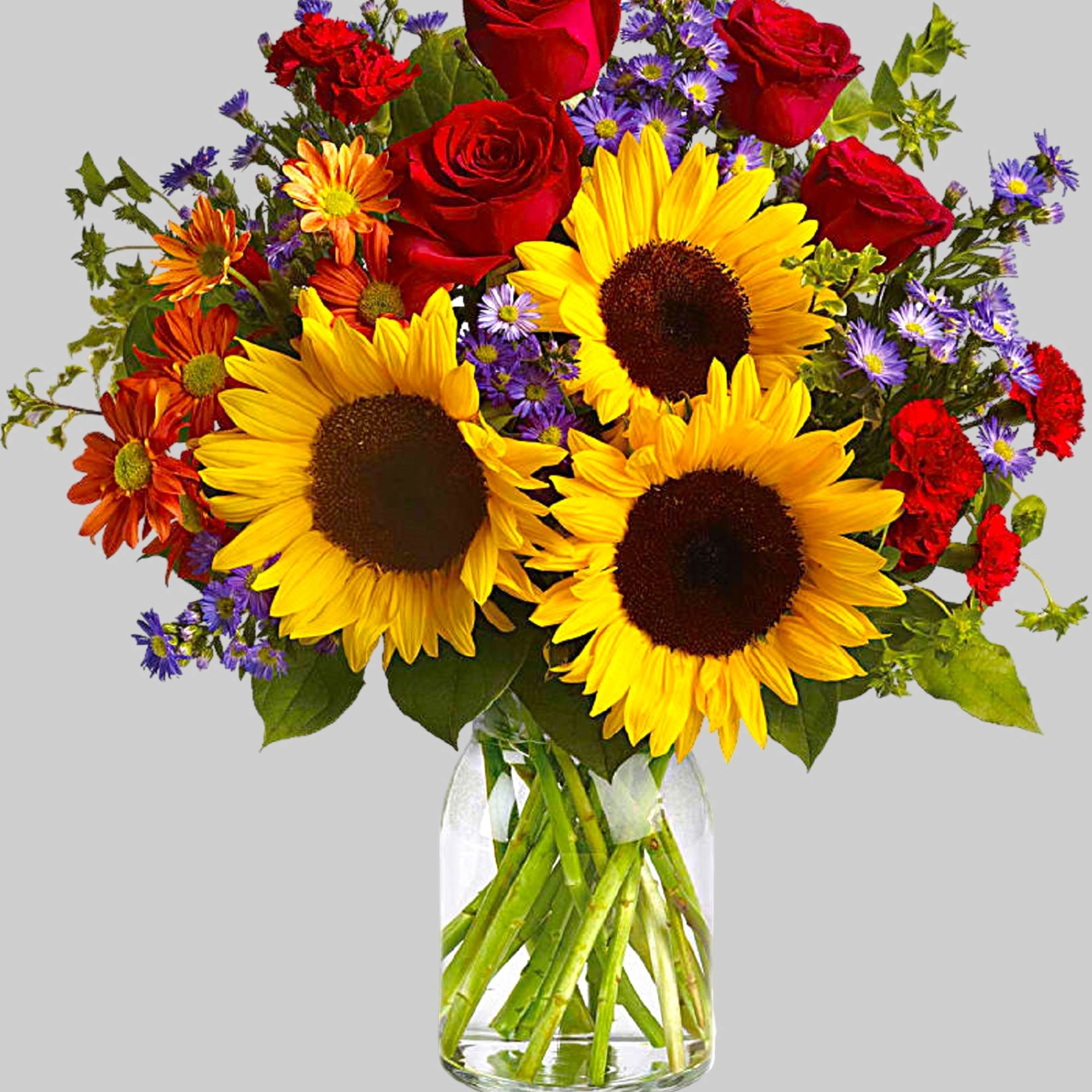 Bouquet of sunflowers, red roses, and purple daisies in a glass vase, photo 4 of 4