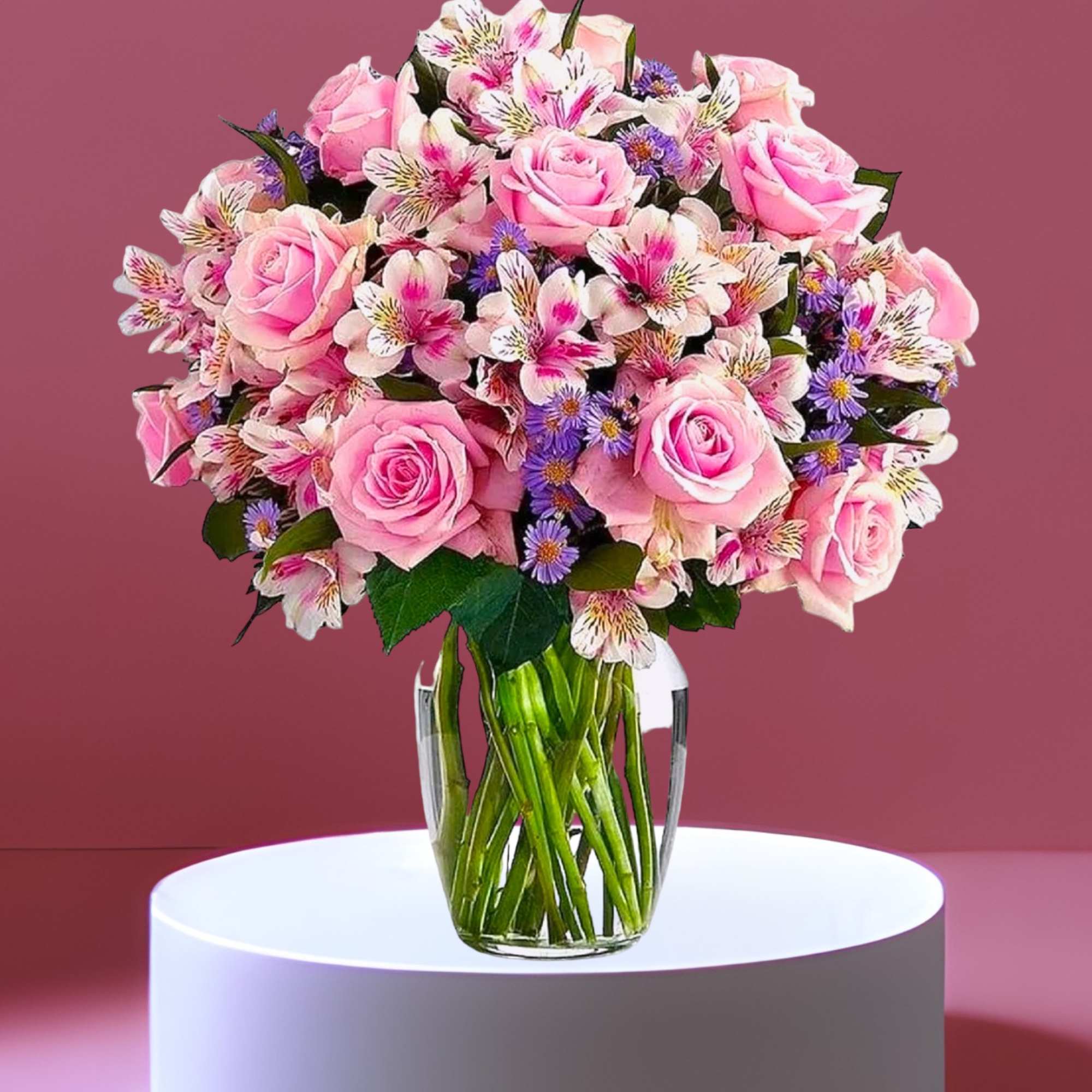Pink roses and alstroemeria in a clear glass vase
