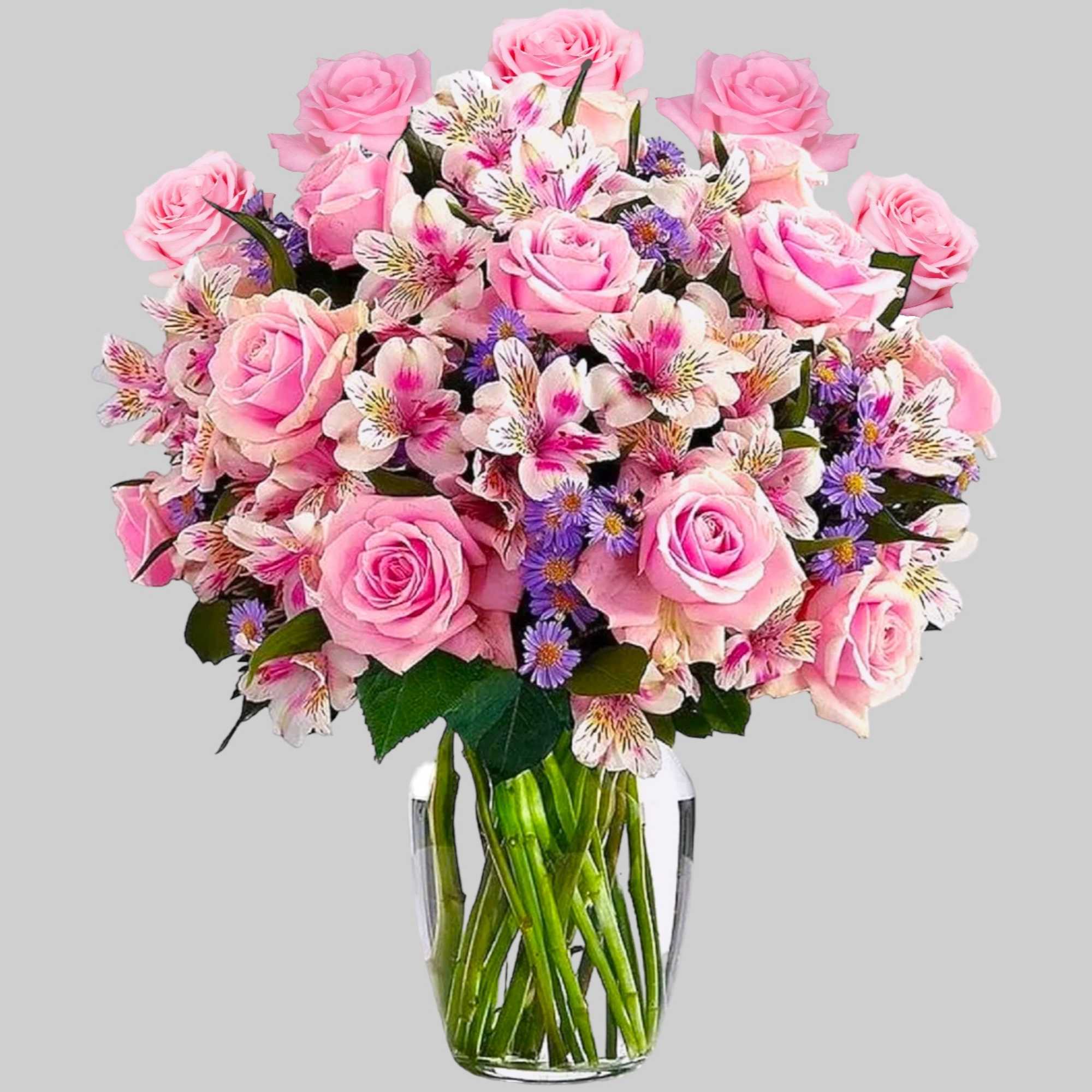 Pink roses and mixed blooms arranged in a clear glass vase, photo 5 of 7
