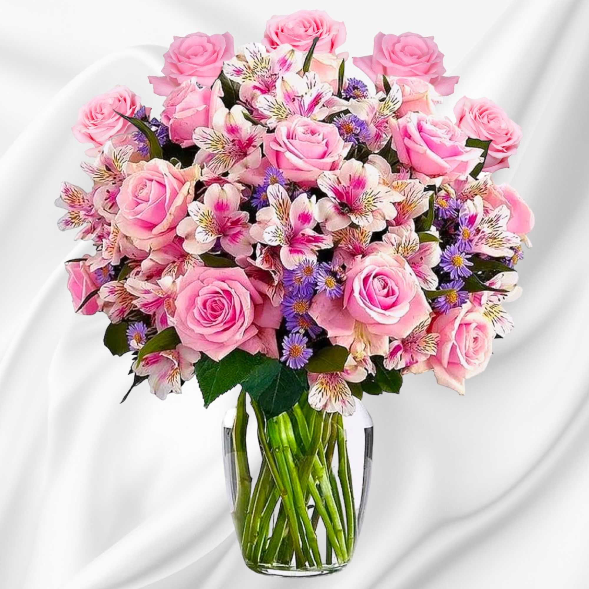 Pink roses and mixed flowers arranged in a clear glass vase, photo 2 of 7