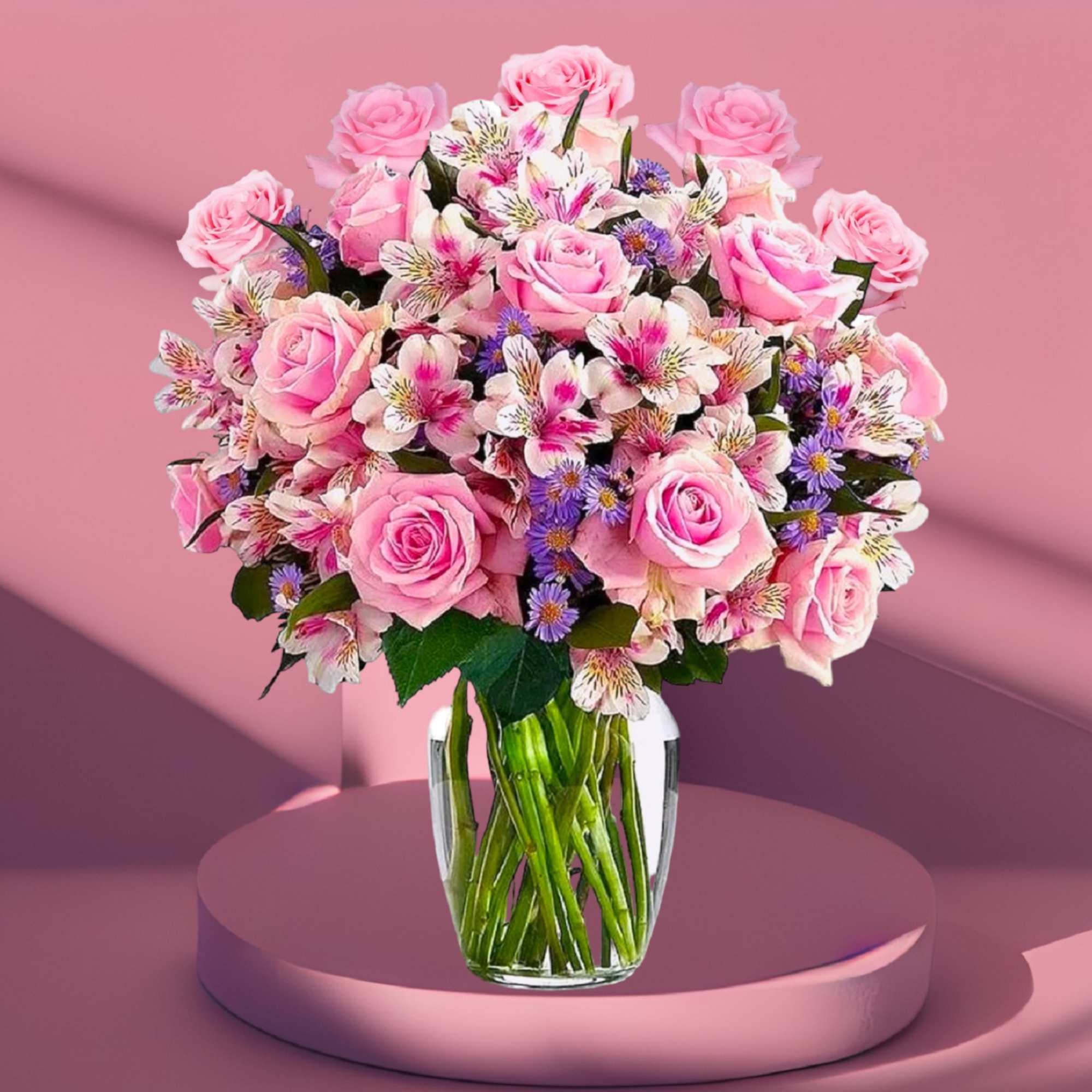 Pink roses and mixed blooms arranged in a clear glass vase, photo 7 of 7
