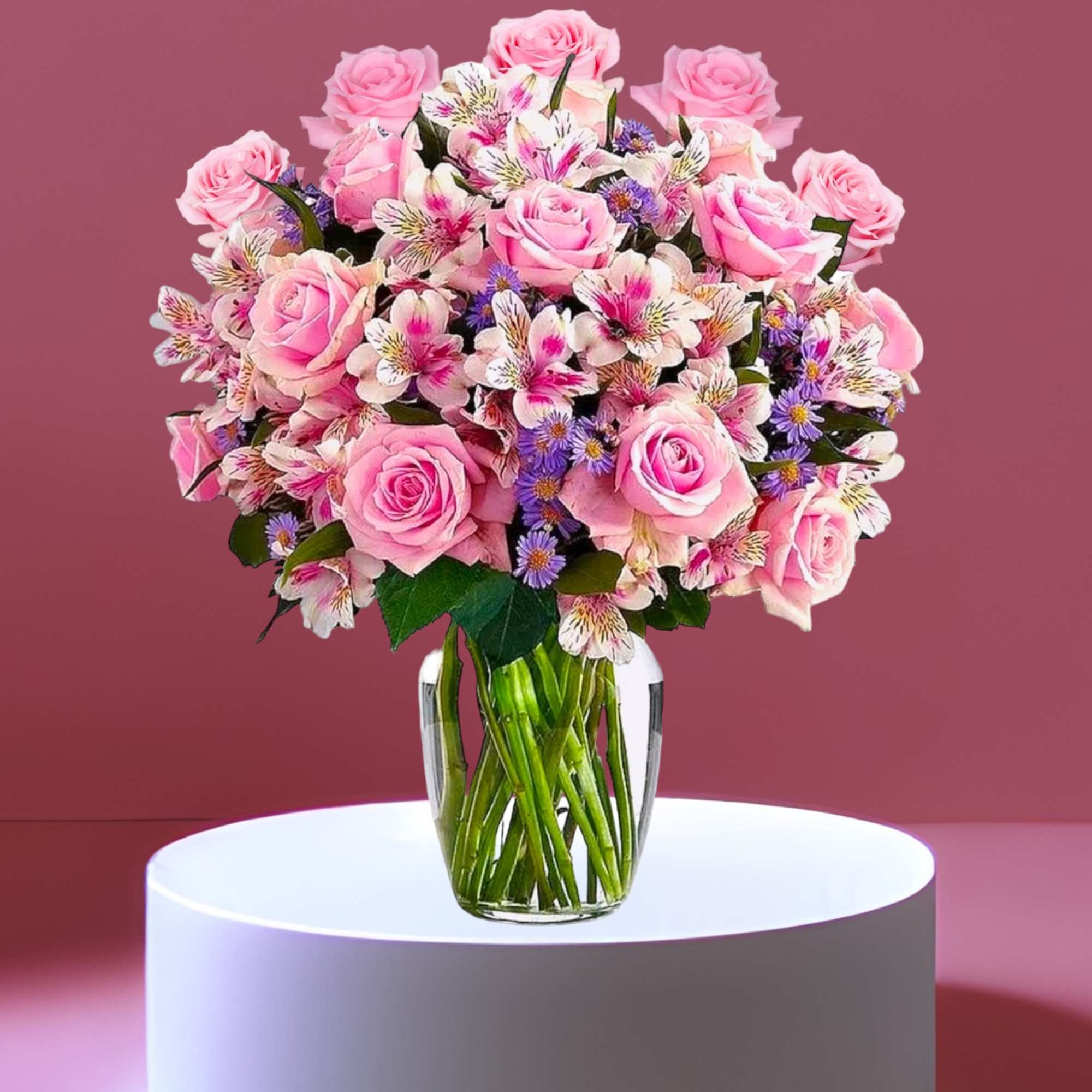 Pink roses and mixed blooms arranged in a clear glass vase, photo 4 of 7