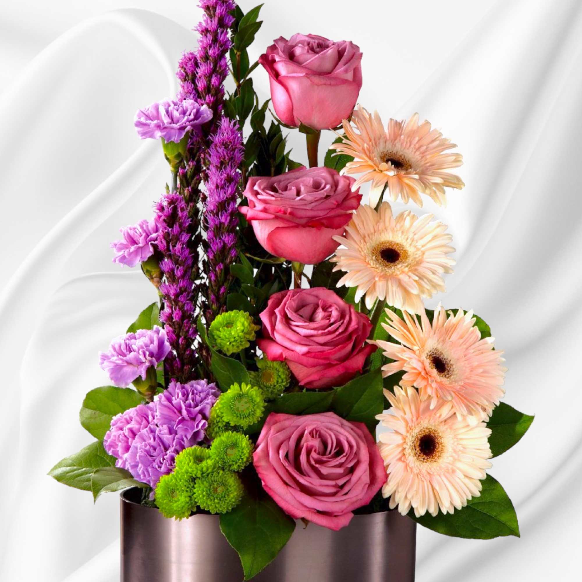 Pink roses and peach gerbera daisies in a metallic vase