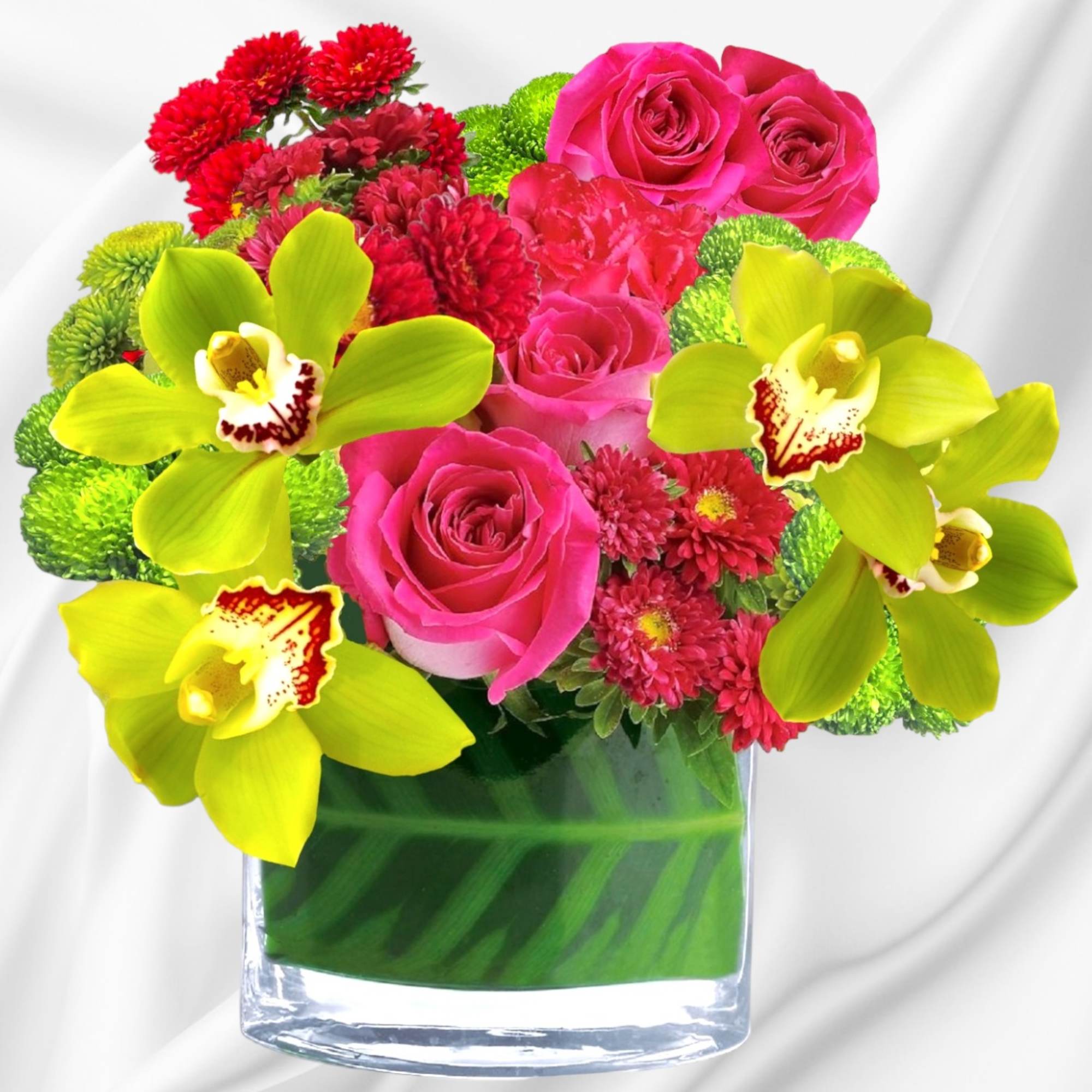 Bouquet of pink roses, red mums, and lime orchids in a glass vase