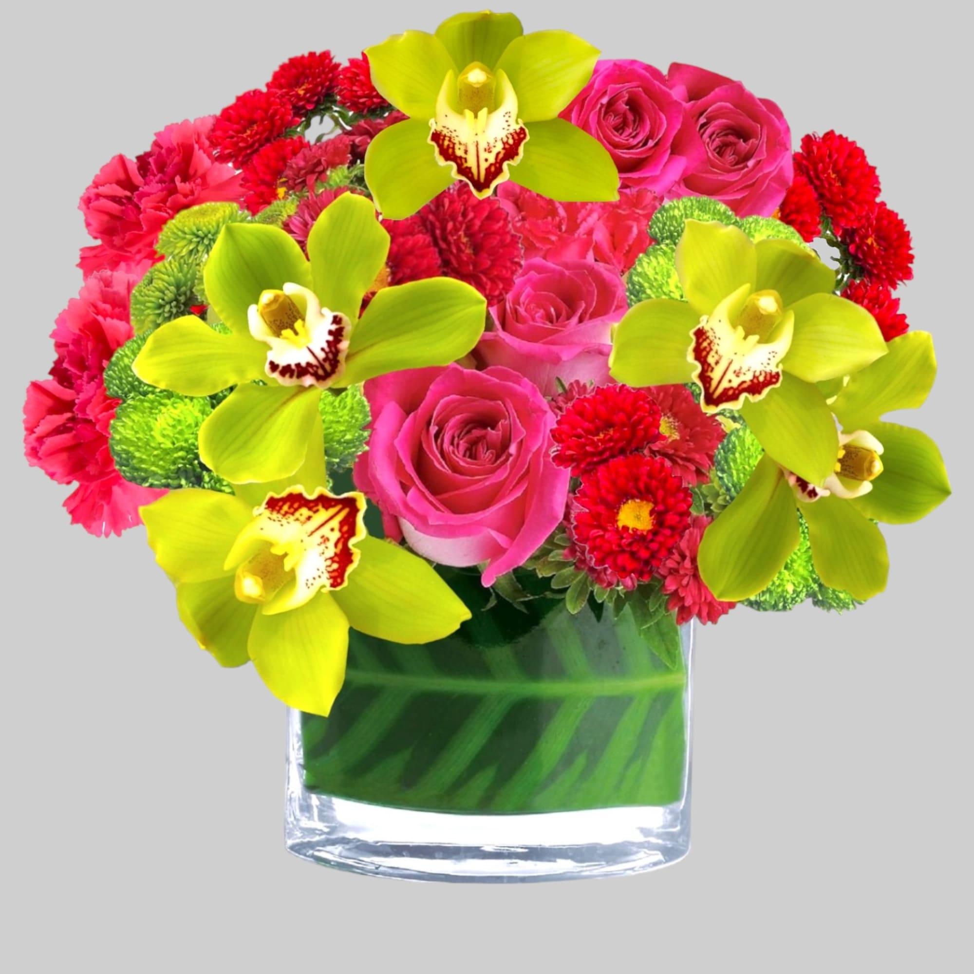 Pink roses, red carnations, and lime orchids in a glass vase