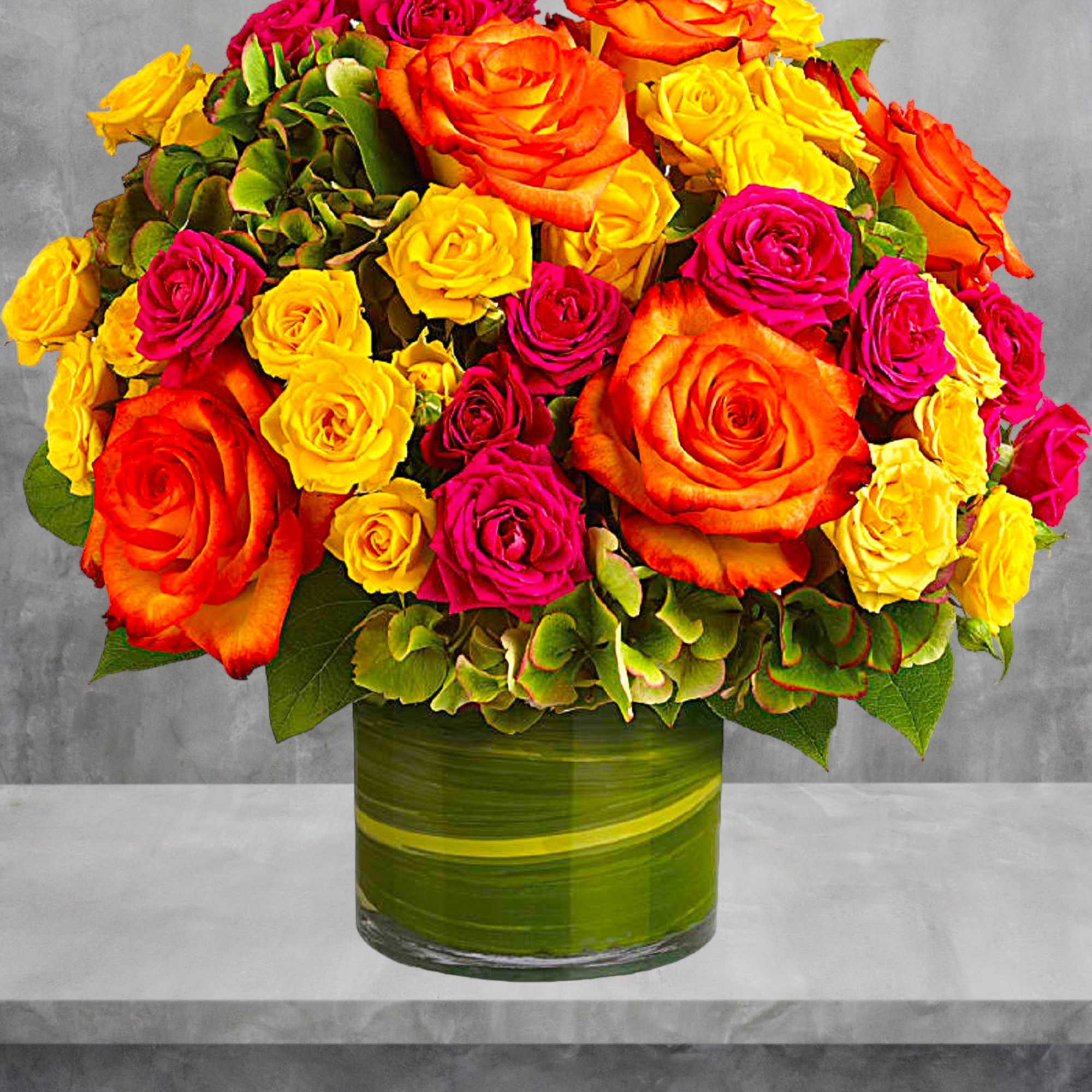 Bouquet of orange, yellow, and pink roses in a green glass vase, photo 3 of 4