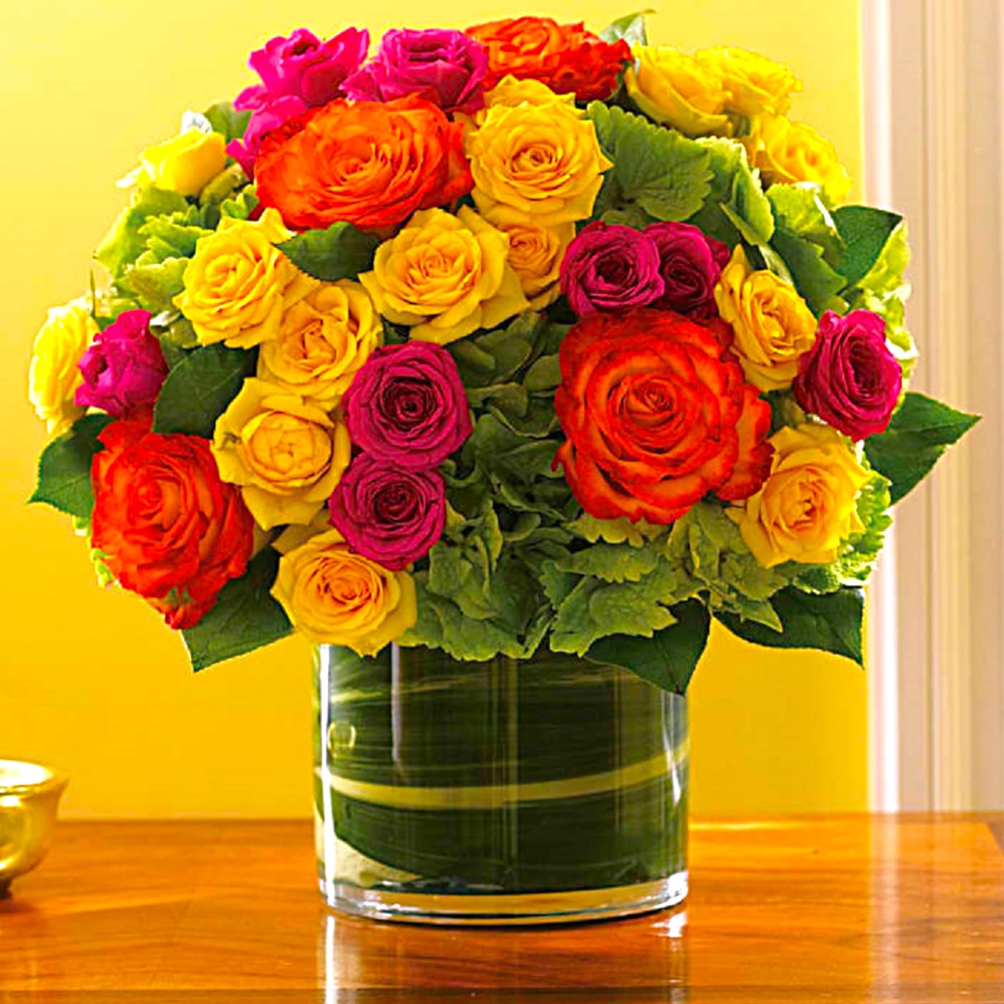 Bouquet of multicolored roses in a clear glass vase