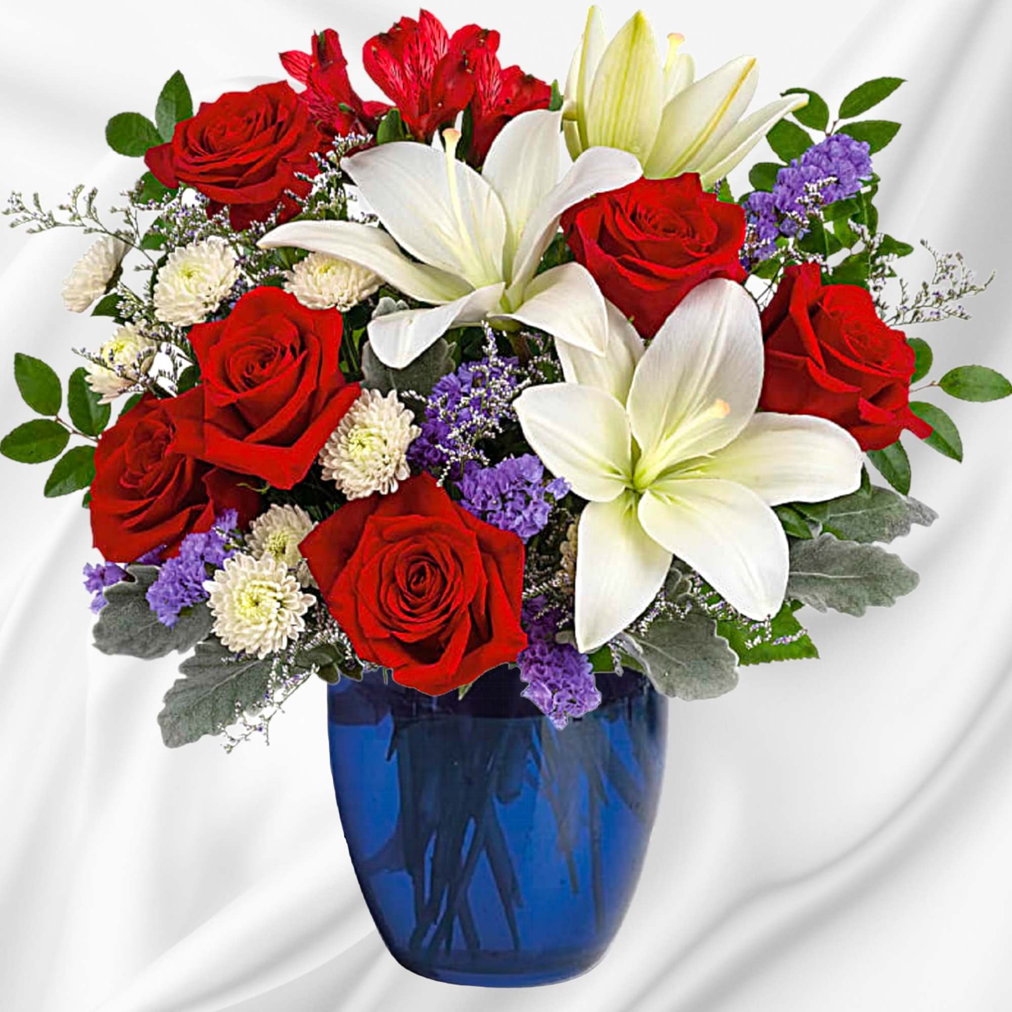 Red roses and white lilies arranged in a blue vase, photo 2 of 4