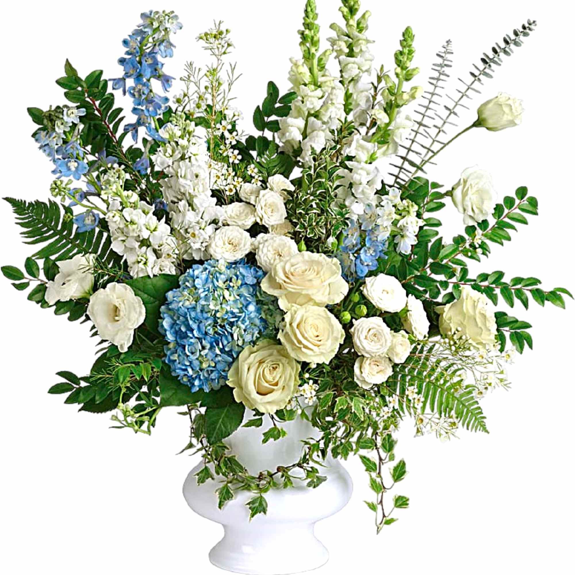 White and blue floral arrangement in a white pedestal vase
